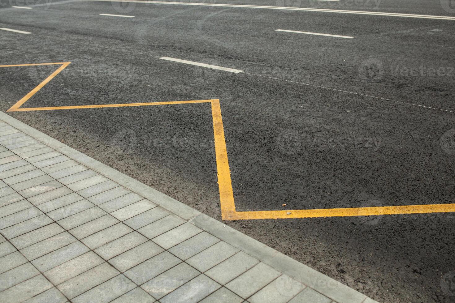 Road markings indicating no stopping or parking photo