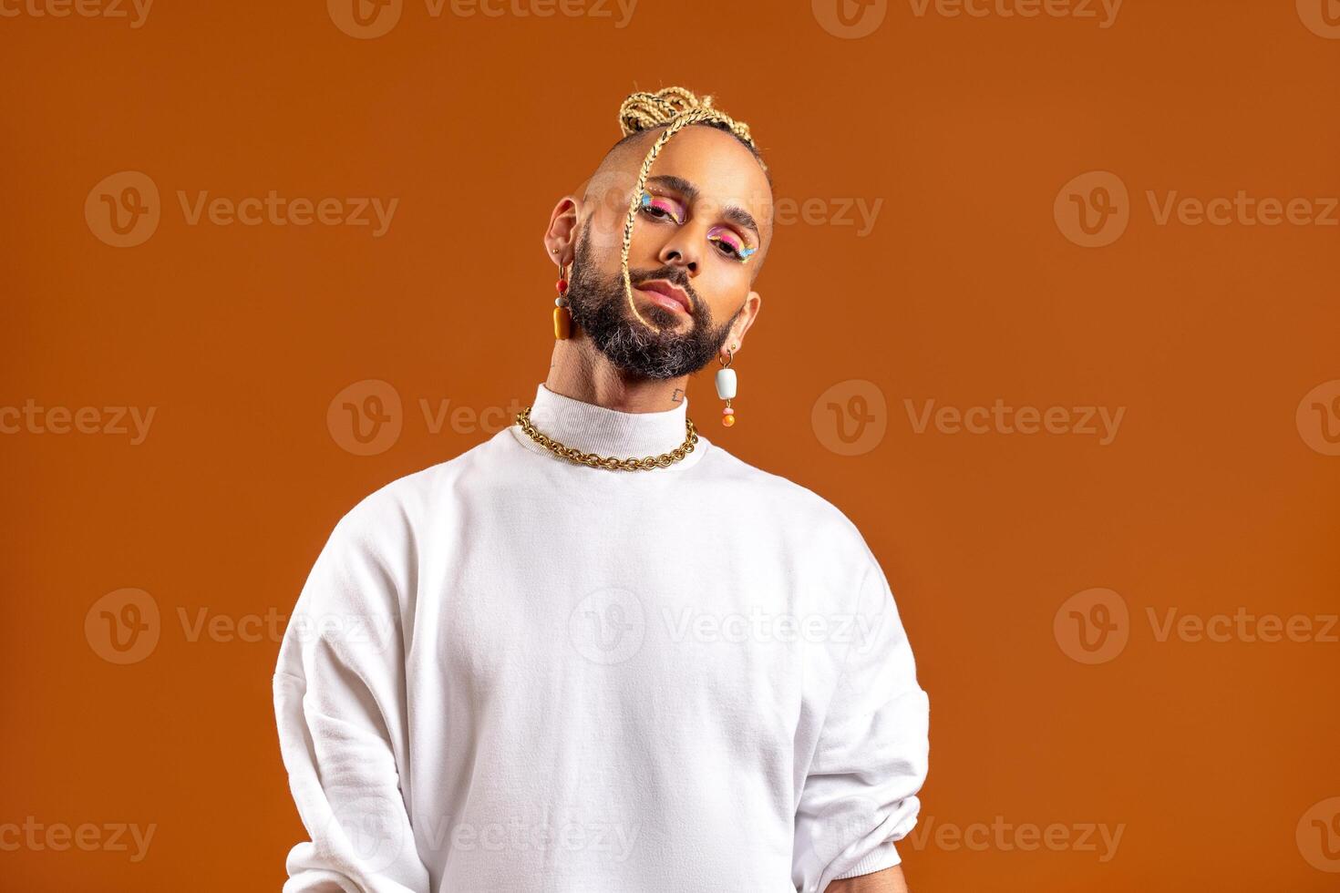 Black latin gay man isolated on orange background photo