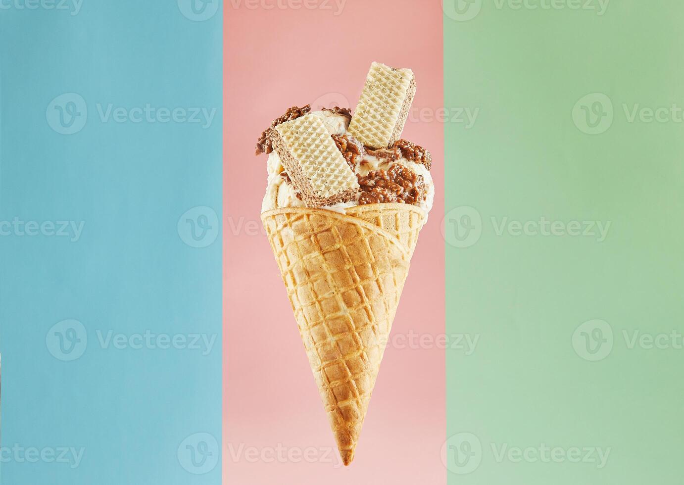 Scrumptious Ice Cream Cone with Wafer and Chocolate Isolated on a Multicolor Background photo