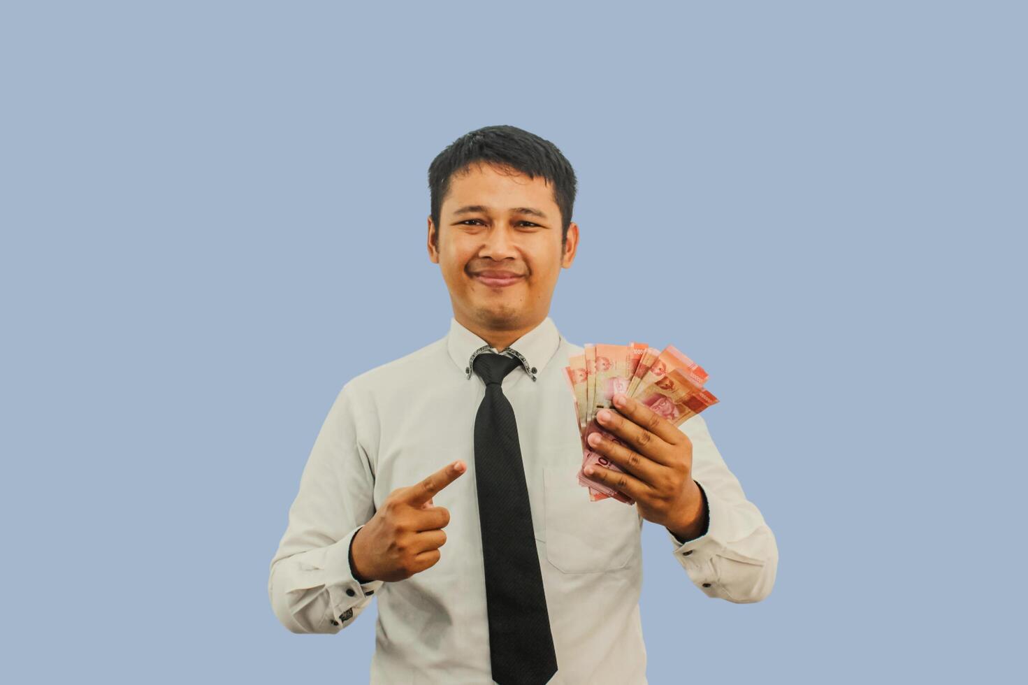 Adult Asian man smiling and showing confident when pointing to paper money that he hold photo