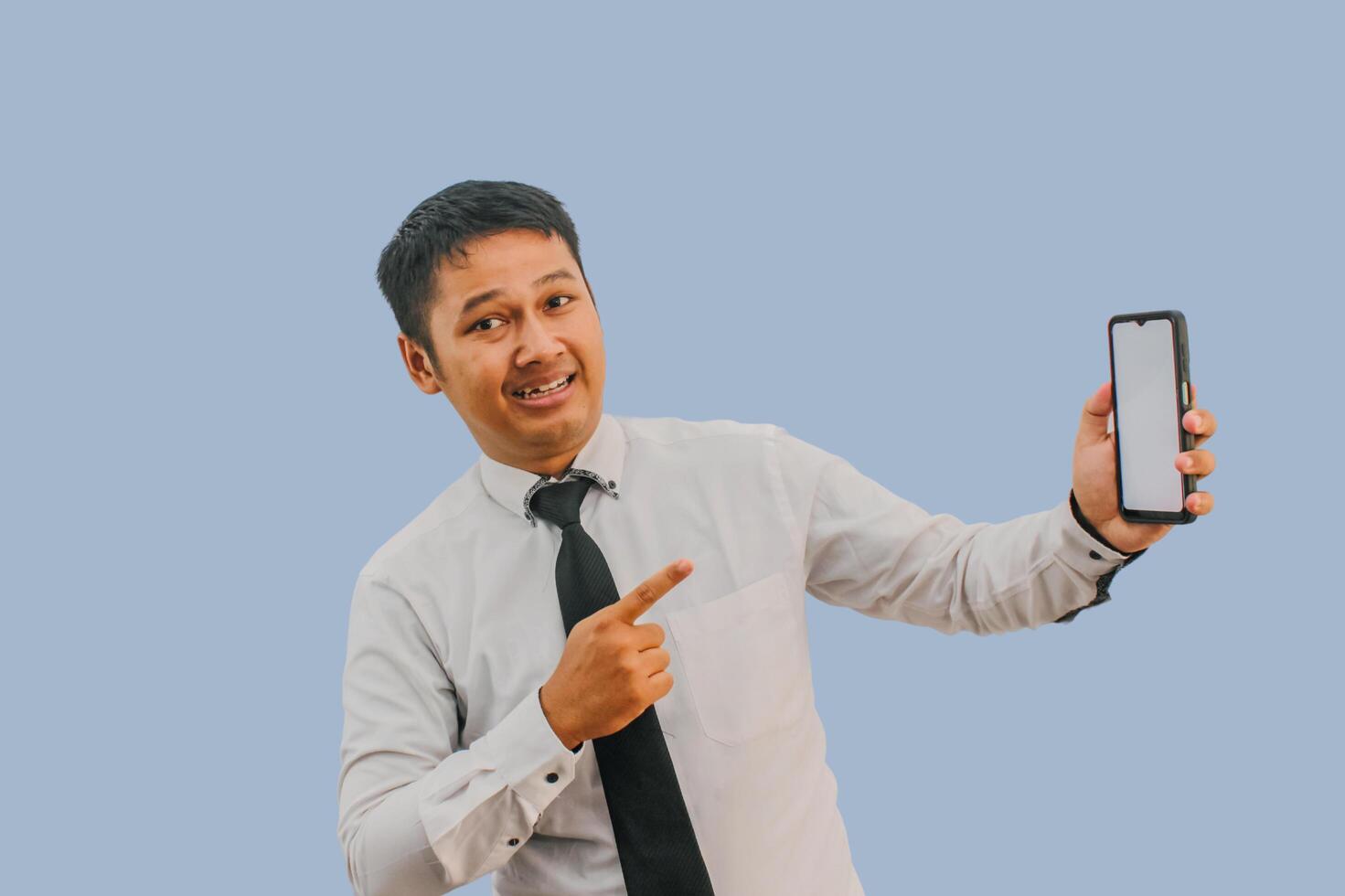 Side View A man showing excited while pointing to blank phone screen that he hold photo