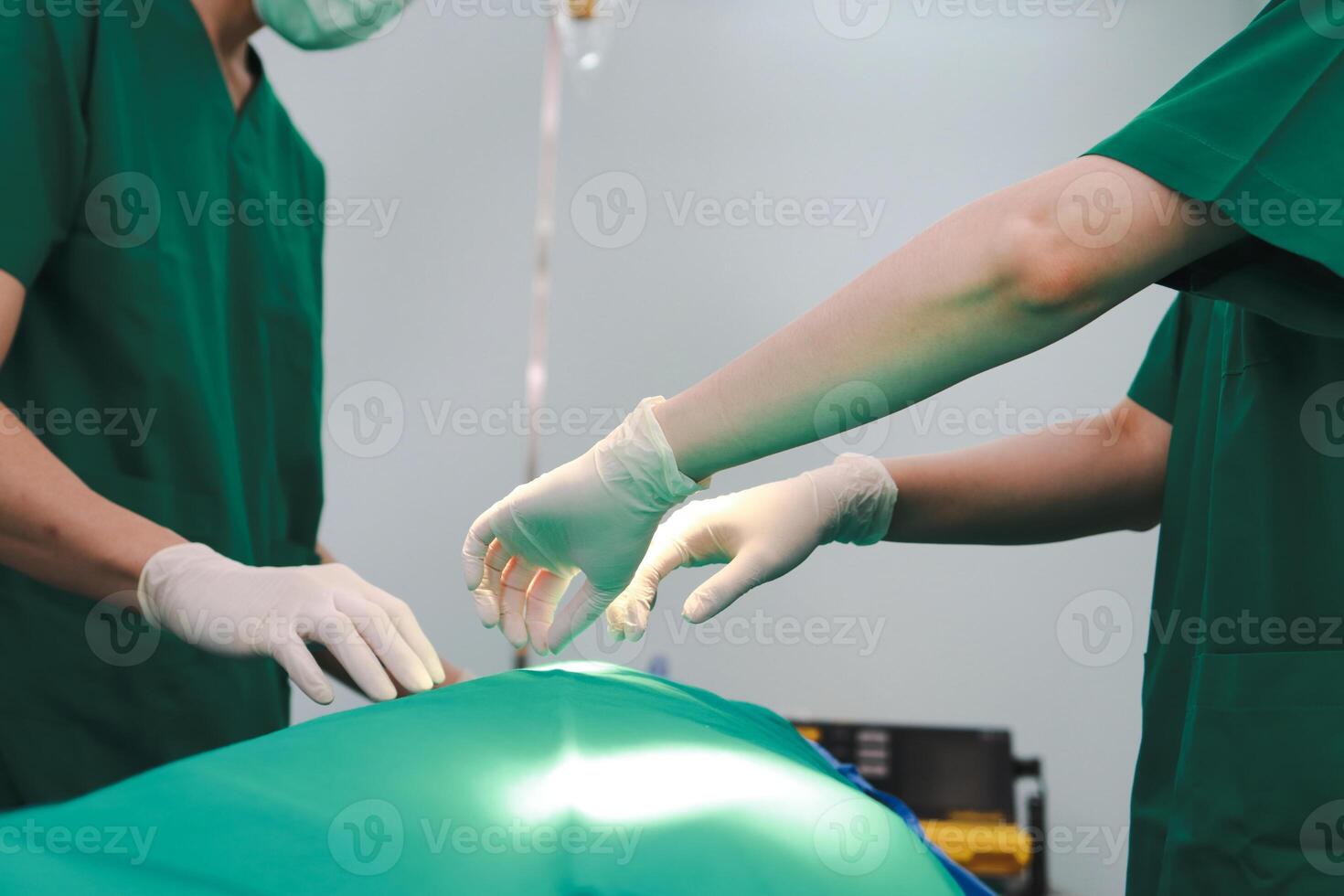 Professional team of Asian surgeons Perform surgery on a patient lying on a bed in a hospital operating room. Medical concepts. emergency surgery photo