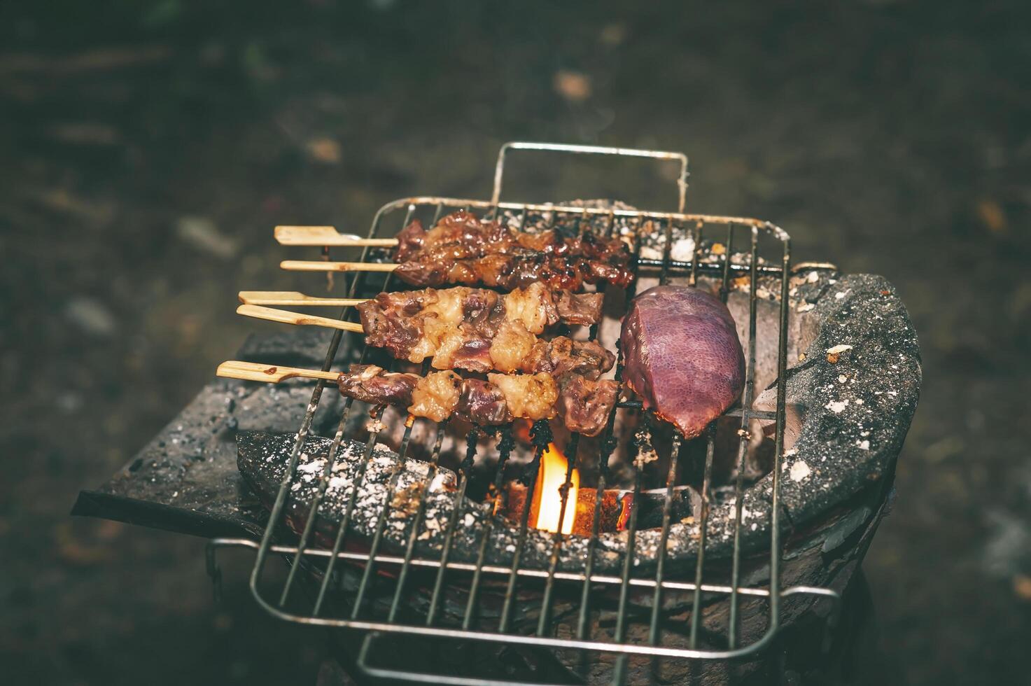 Pieces of beef skewers grilled on a skewer in a clay oven. photo