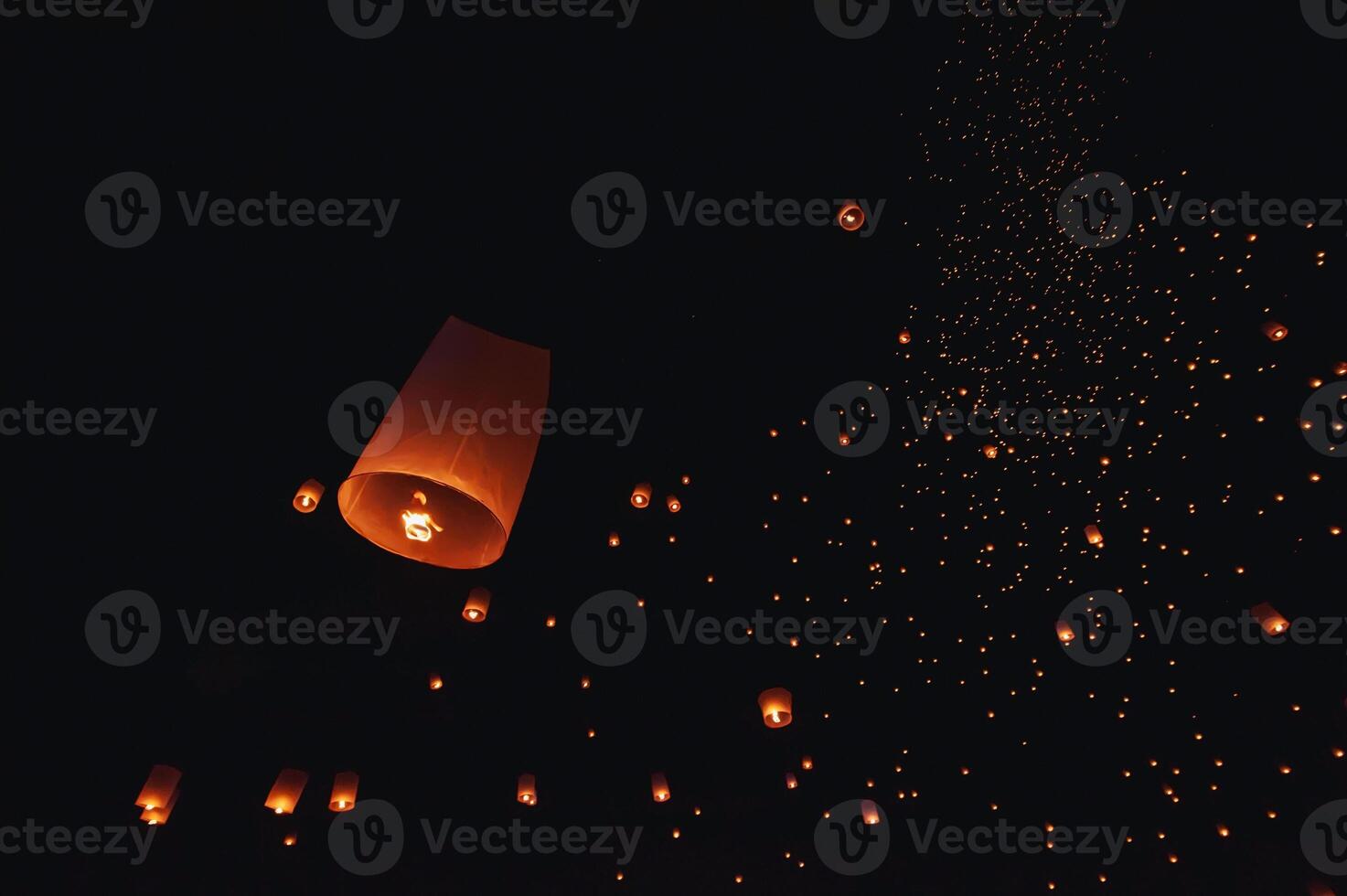 The beauty of the lanterns floating in the sky during the Yi Peng Festival and the Floating Lantern Festival in Chiang Mai Province, Thailand. photo