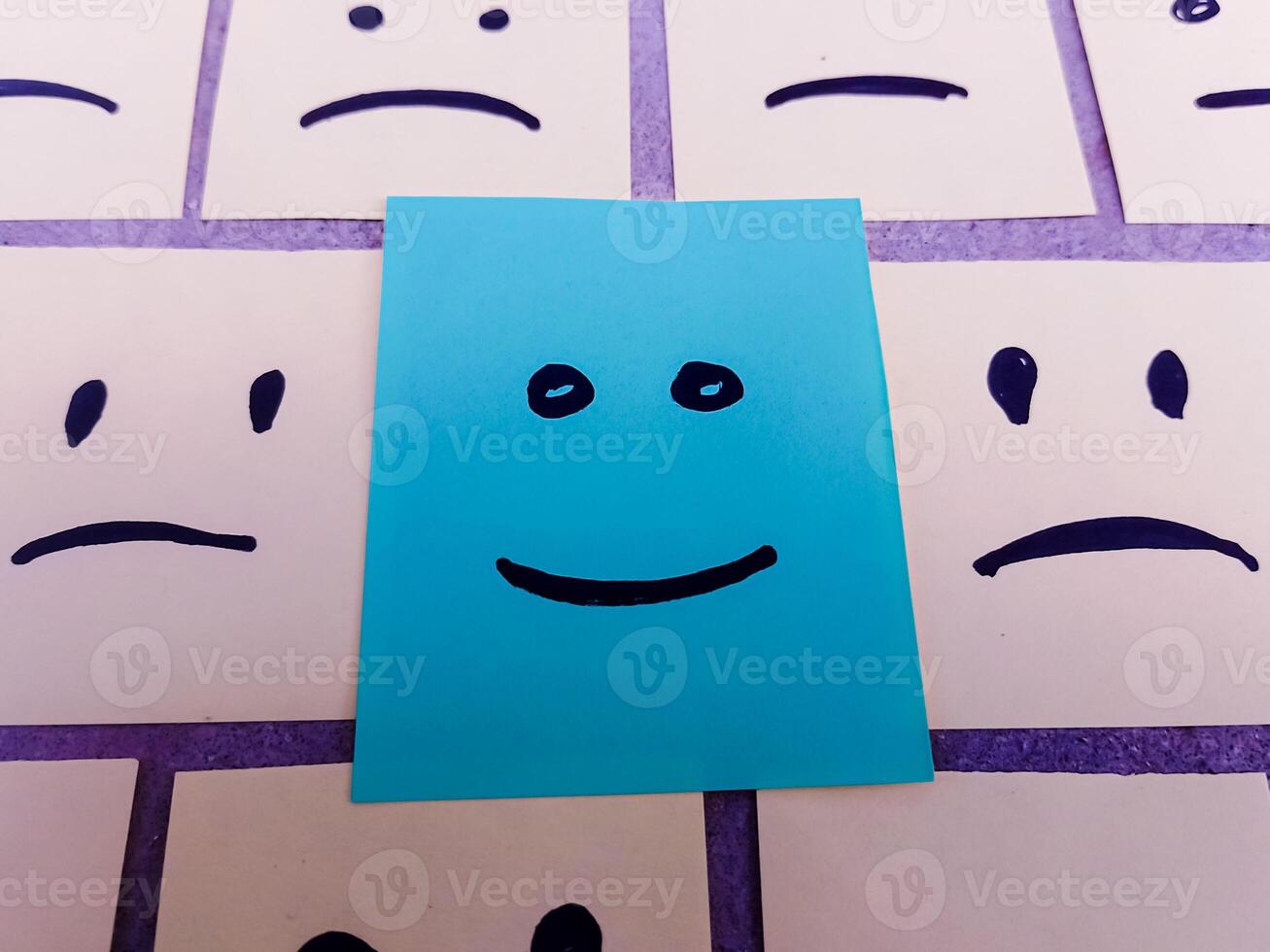 sticky notes with All sad and one Happy face - Unhappy and Happy Team Concept photo