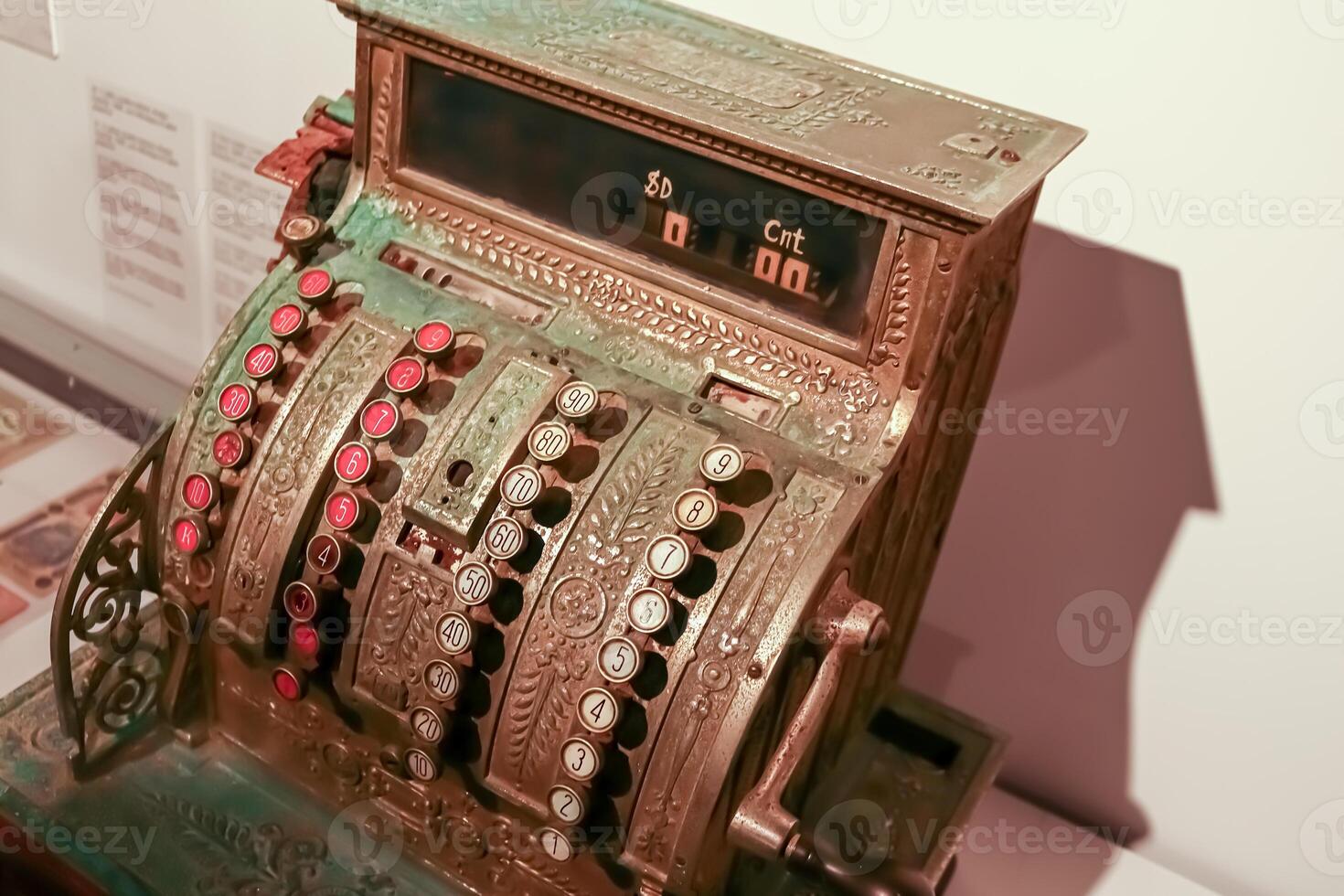 Vintage cash register with round buttons with numbers in a sepia tone top down view photo