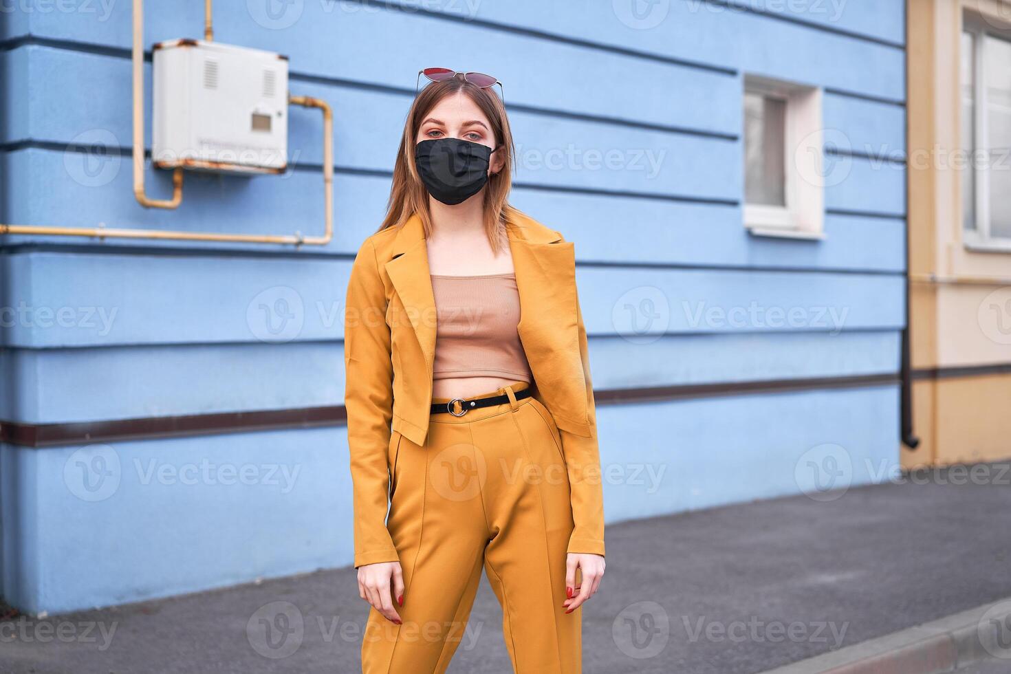 Young Caucasian European girl 20 years old wearing black protective medical mask protection against epidemic coronavirus covid-19 photo