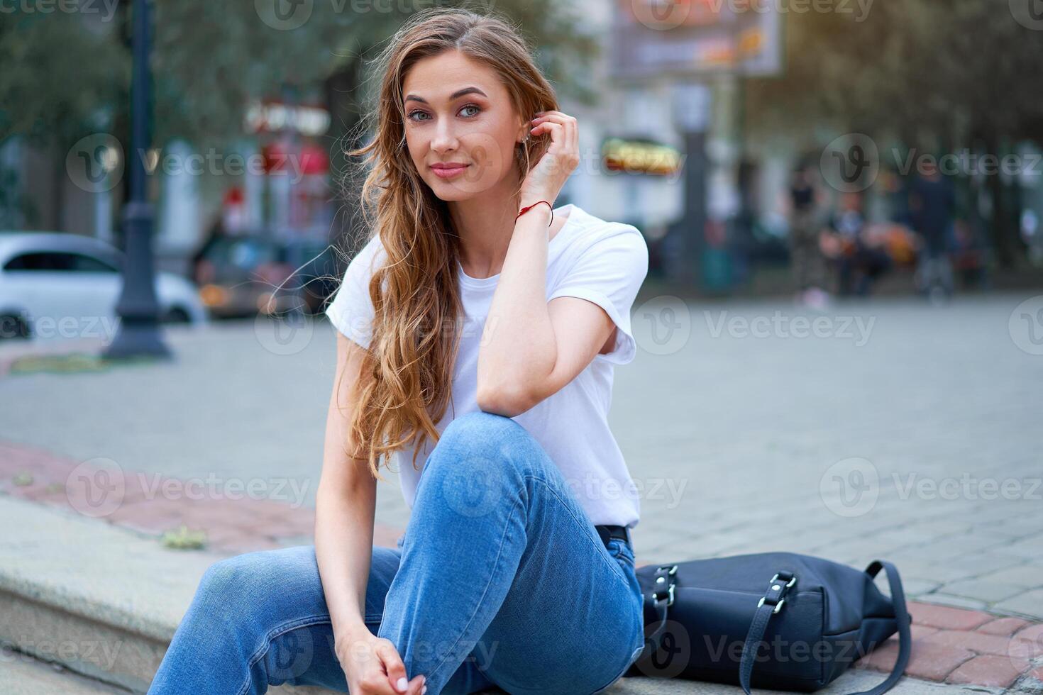 Woman city street summer sitting stairs outdoor park Modern stylish travel girl with backpack resting happy smiling on city street photo