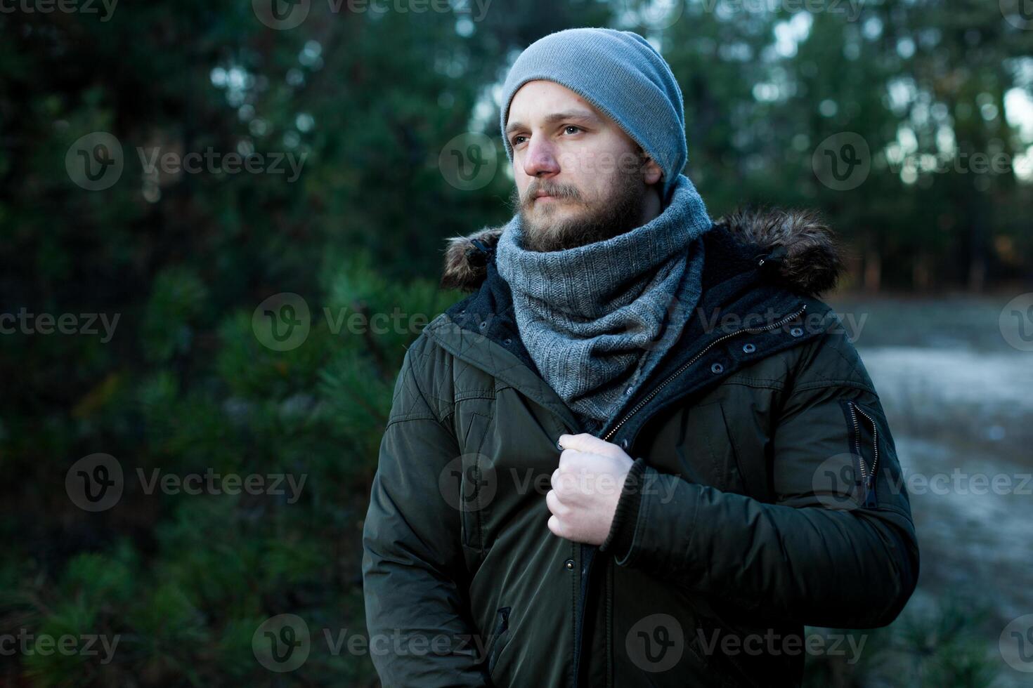 Portrait brutal bearded hipster man in the forest photo