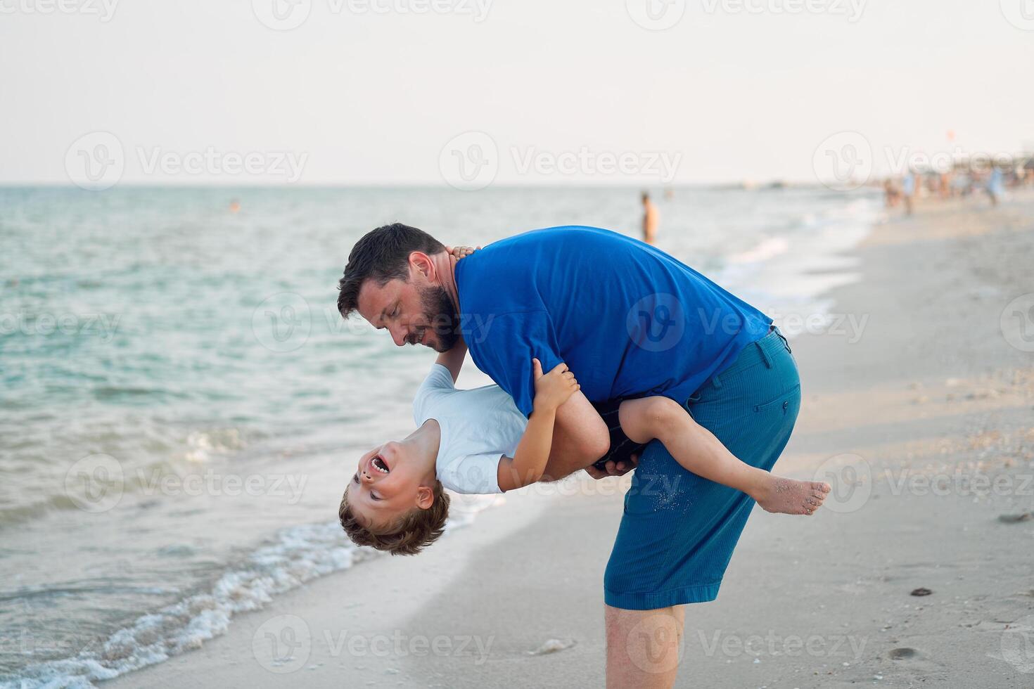 Father son spending time together sea vacation Young dad child little boy walking beach photo