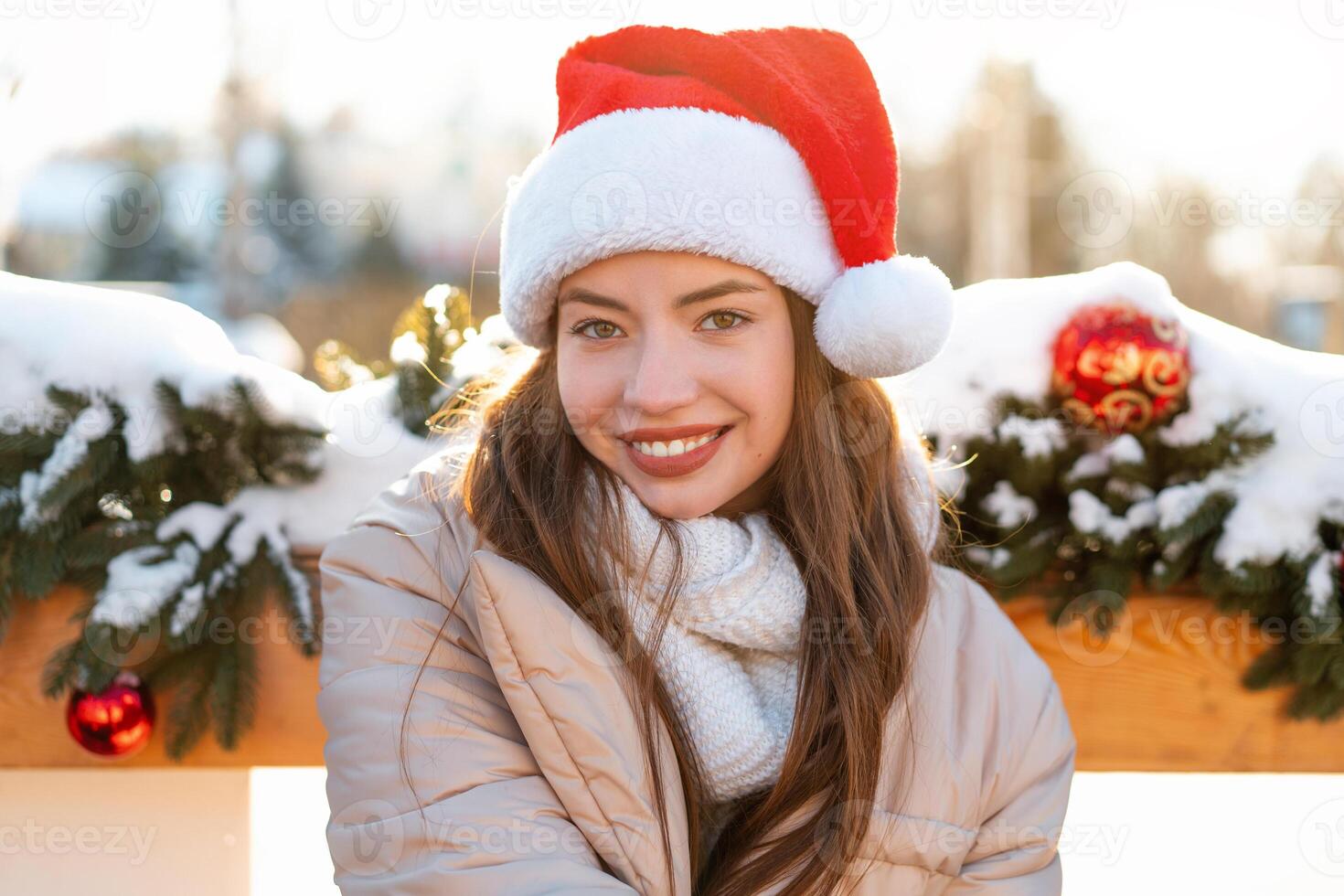 Winter portrait young adult beautiful woman in Santa hat. Christmas mood. Snowing. Winter beauty fashion concept photo