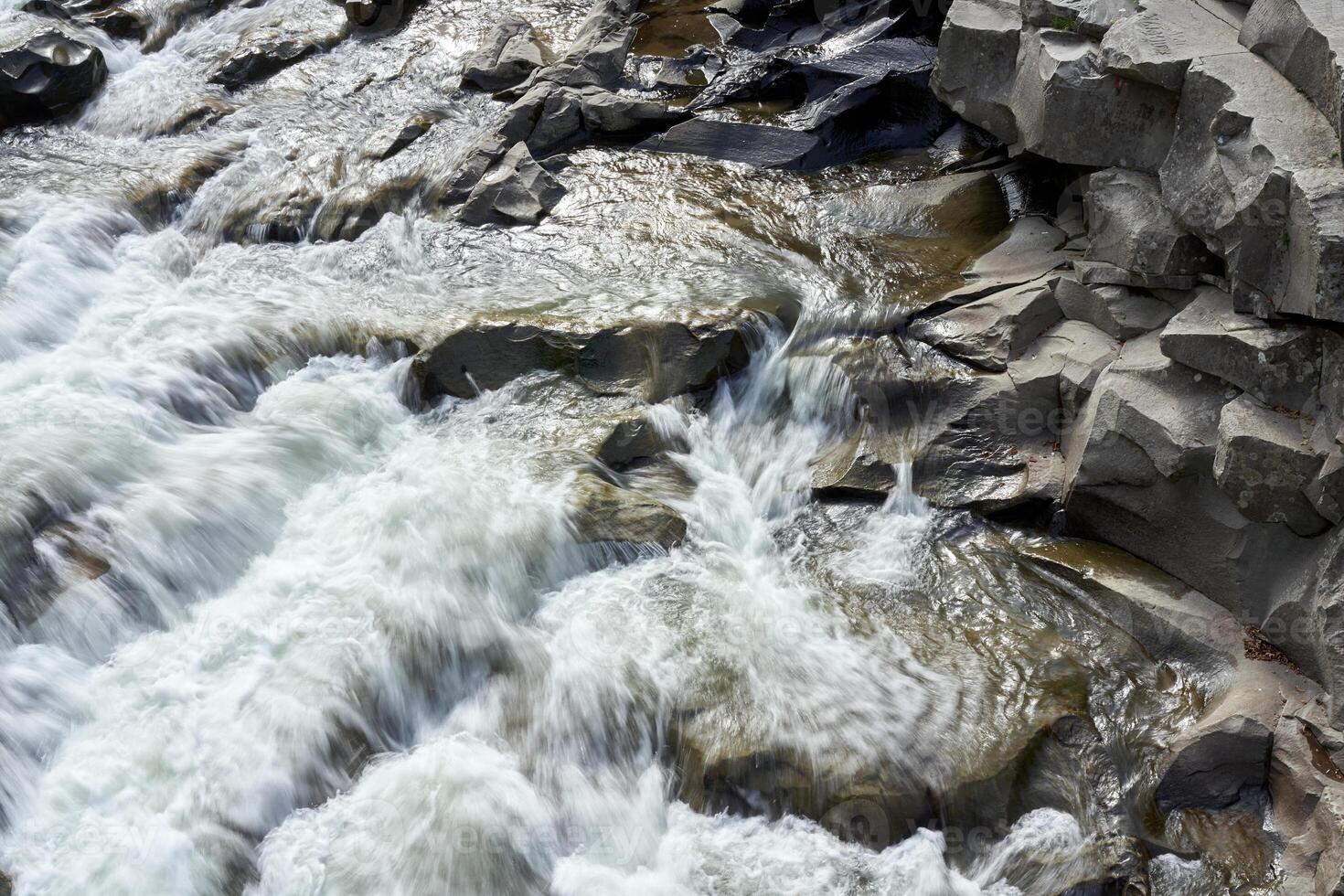 Mountain river with blured water close up photo