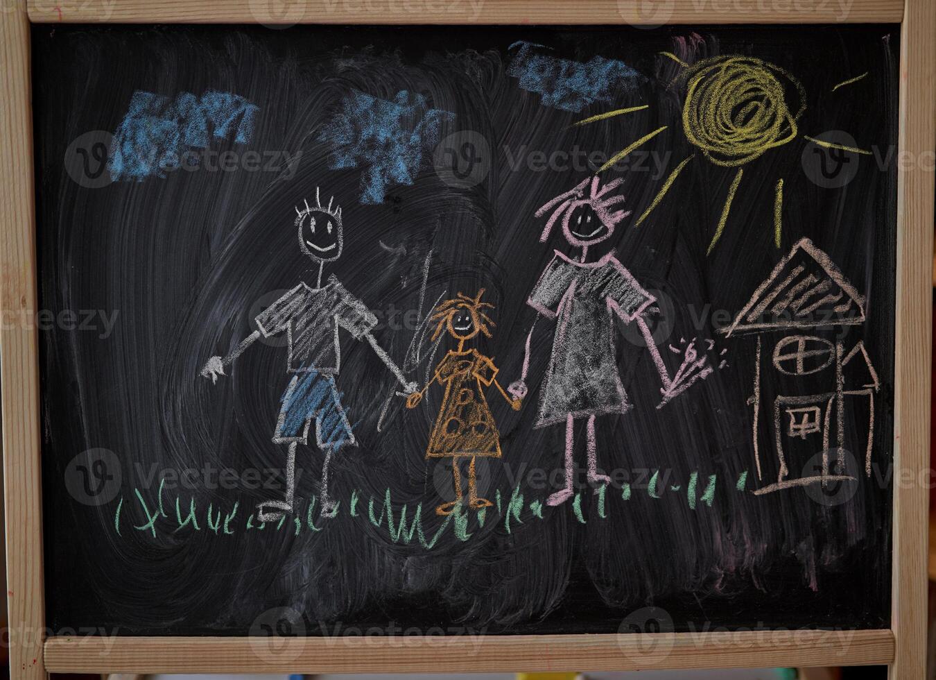 Children multicolored chalk drawing on blackboard photo