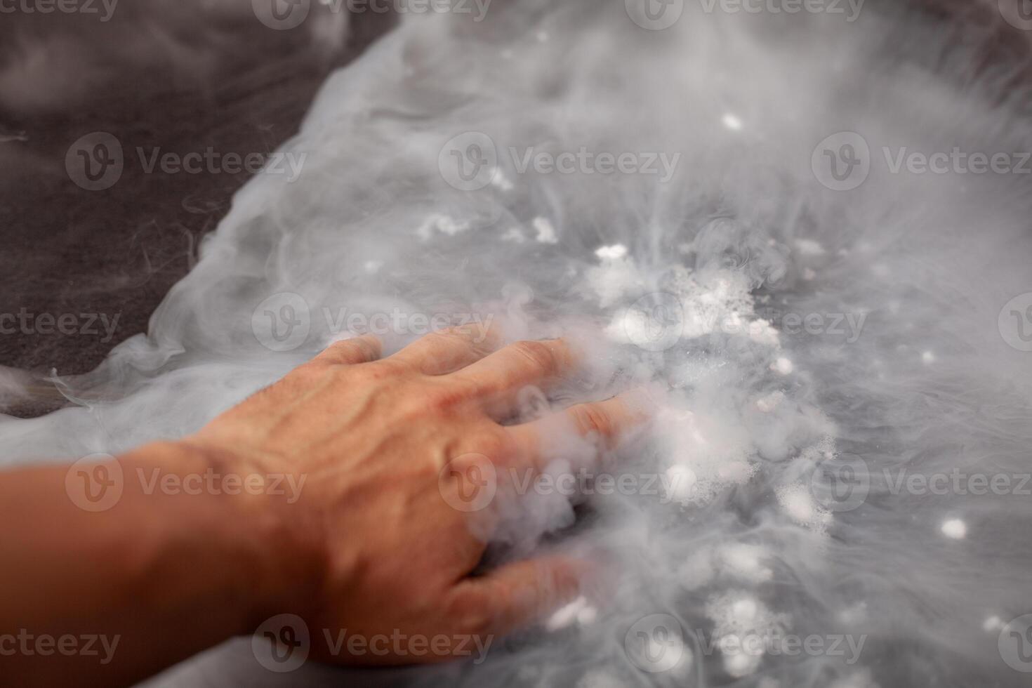 Thick white smoke on a background of black ceramic tiles. photo