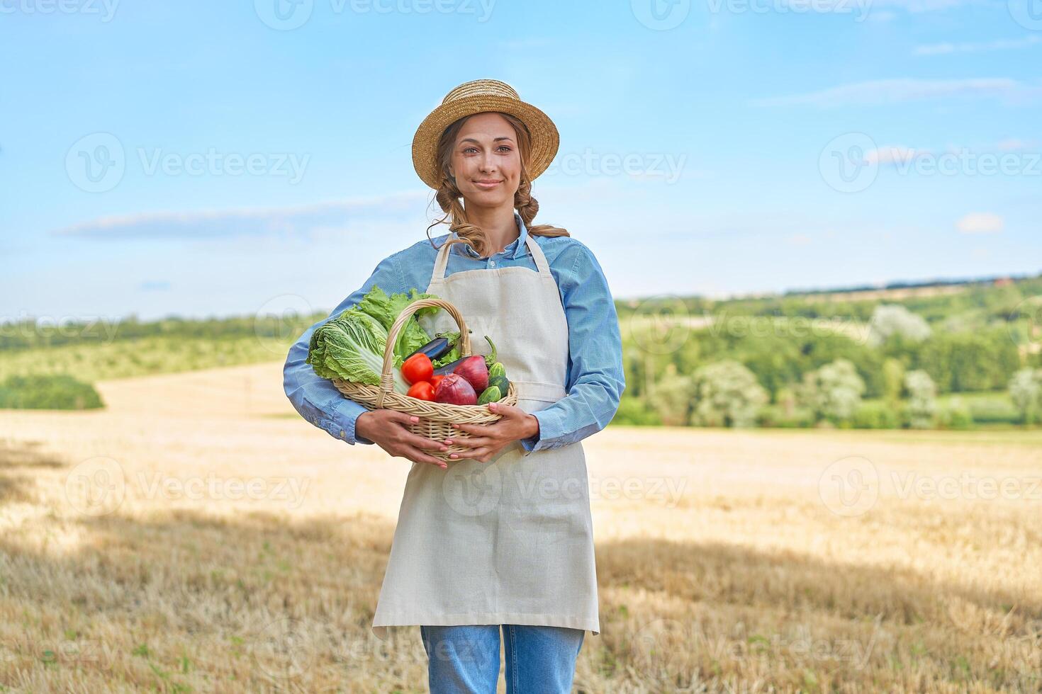 Woman farmer straw hat apron standing farmland smiling Female agronomist specialist farming agribusiness Happy positive caucasian worker agricultural field photo