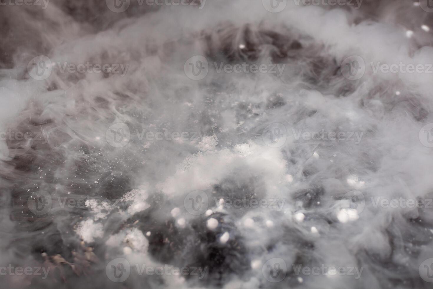 Thick white smoke on a background of black ceramic tiles. photo