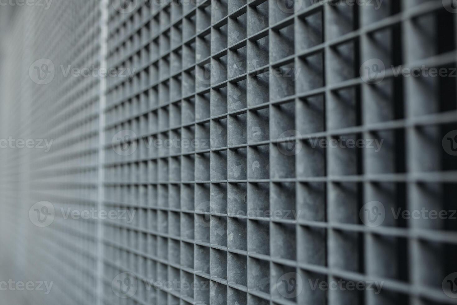 Metal lattice with small cells grid stock background with shallow dof and selective focus photo