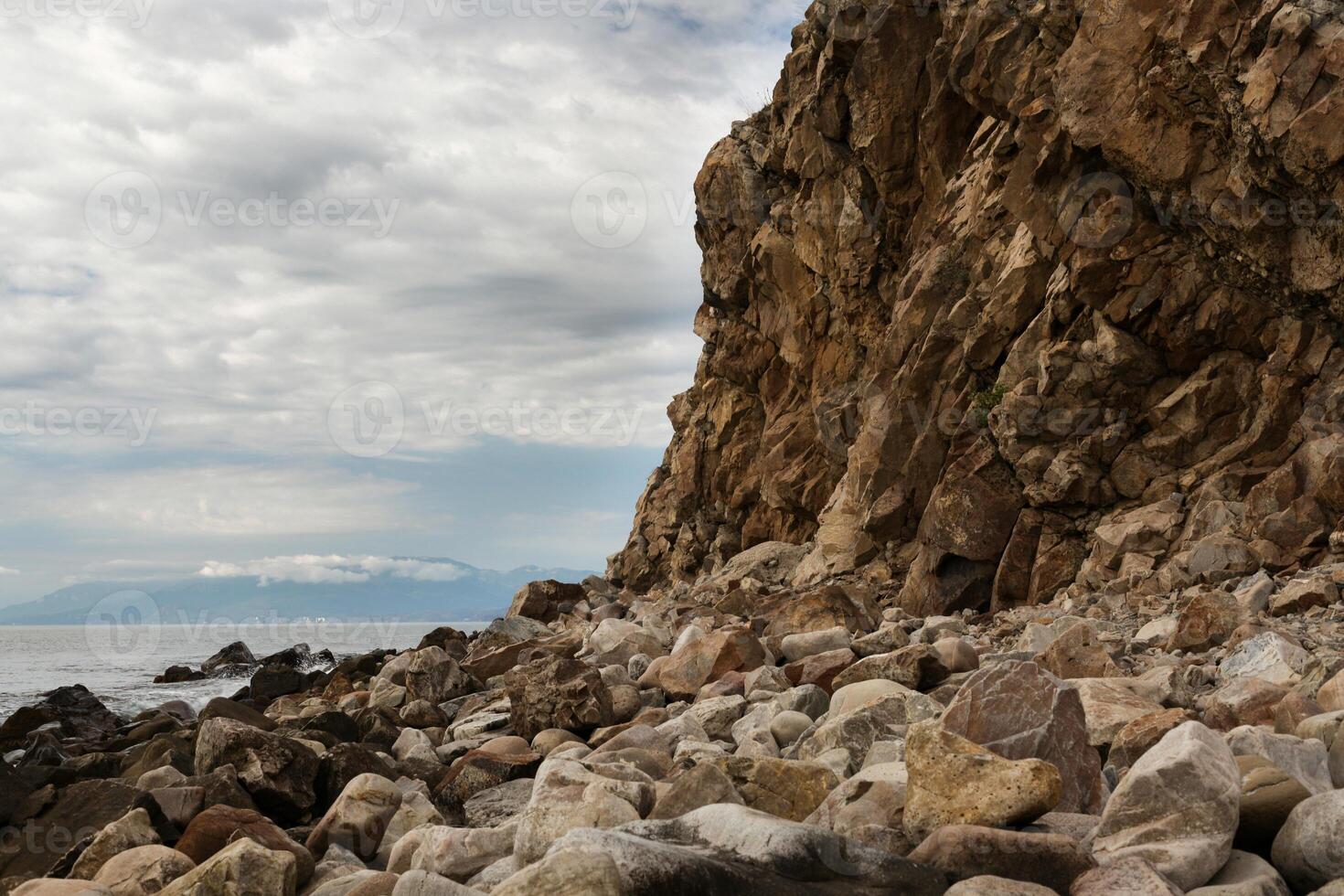 yellow rock near the sea photo