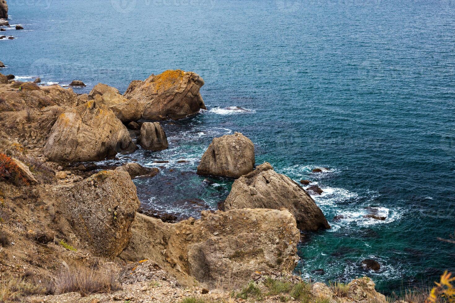 big stone rock over the sea water photo