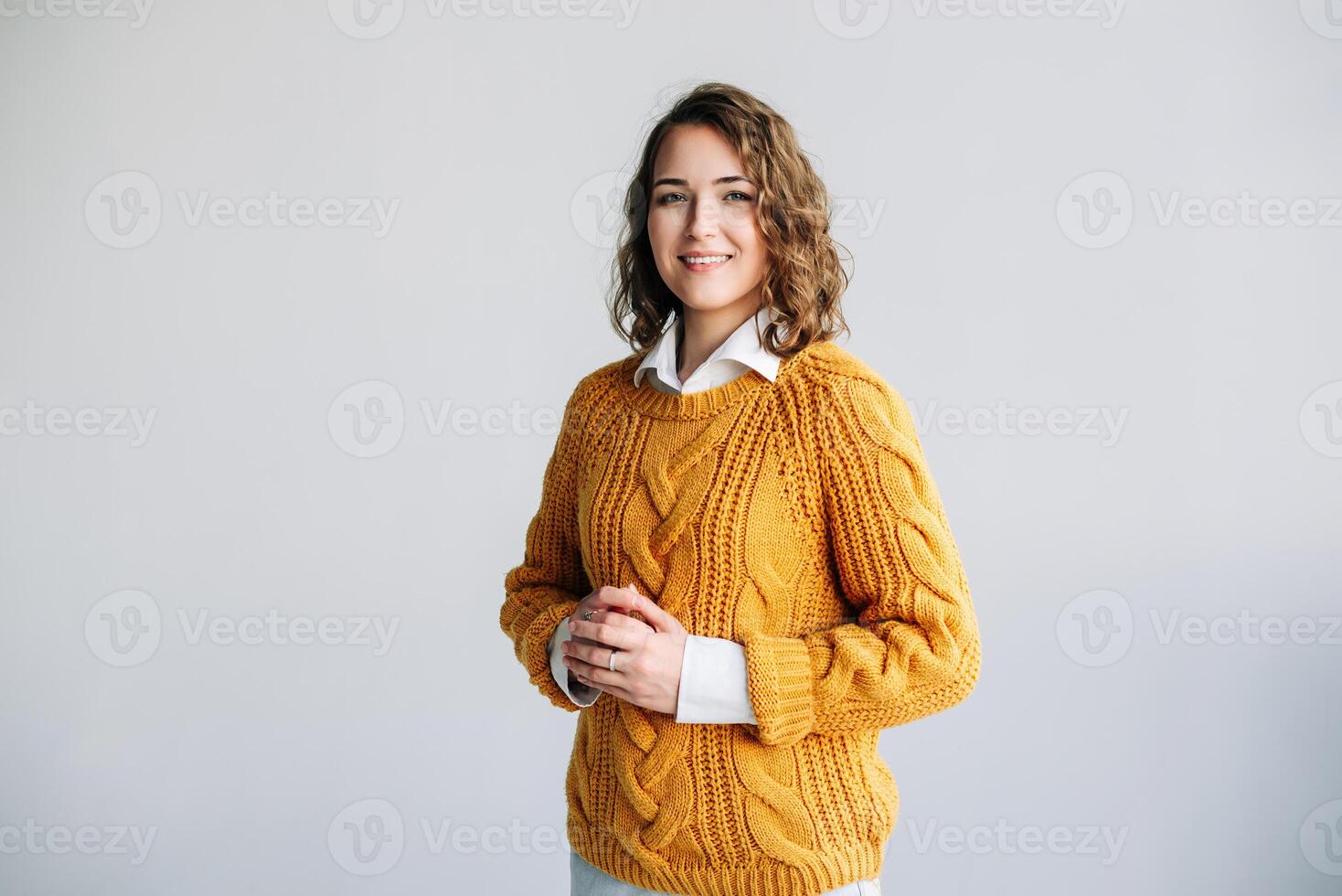 Joyful Professional Woman. Smiling, Beautiful, and Charming Model - Positive, Cheerful, and Pretty - Curly-haired Student Looks at Camera - Isolated Portrait - Confident and Vibrant Expression photo