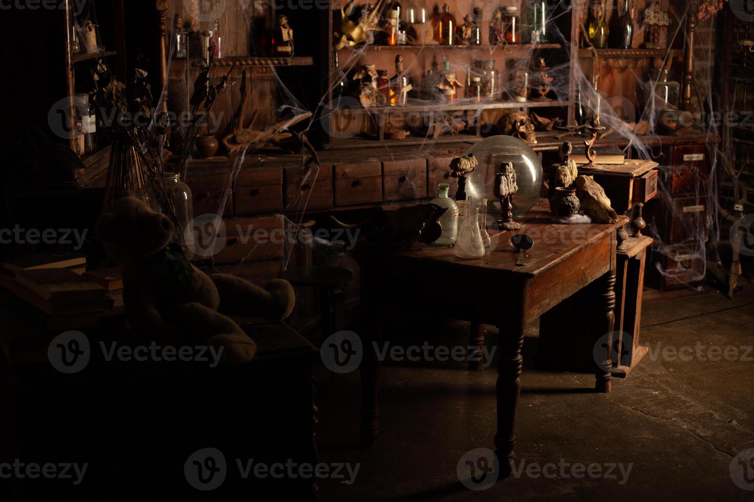 Halloween background Shelves with alchemy tools Skull spiderweb bottle with poison candles photo