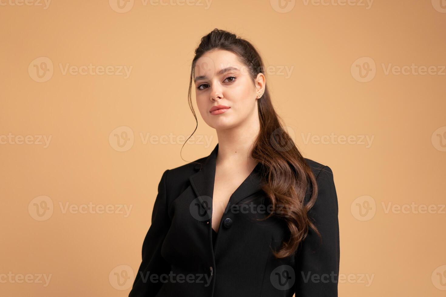 Young business woman close up portrait dressed black jacket standing studio isolated on color background. photo