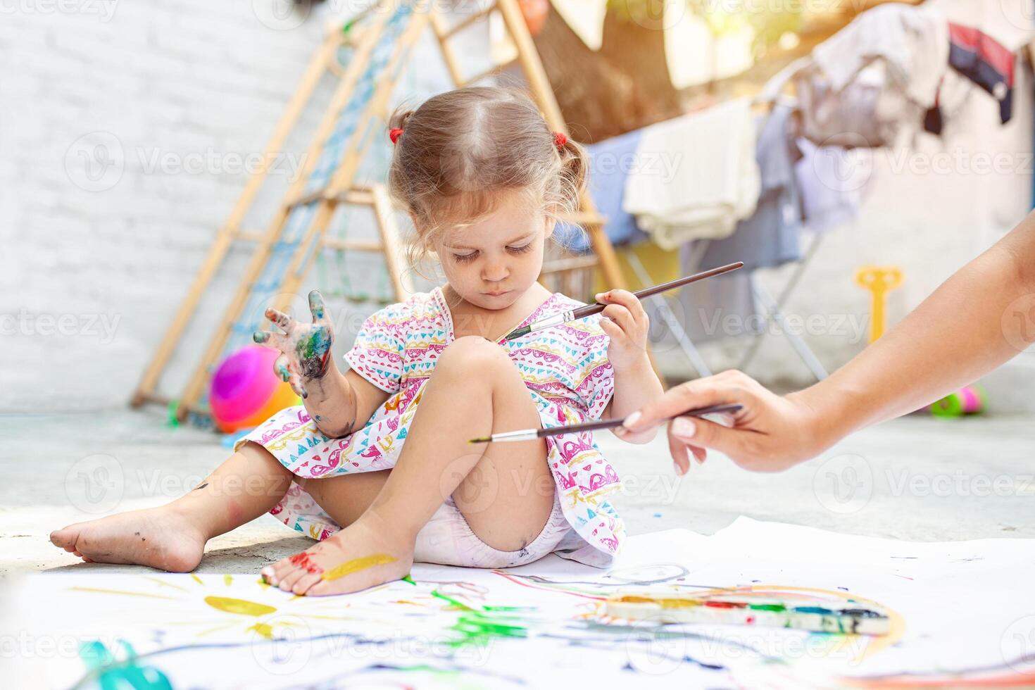 Child Girl Drawing Picture Outdoors in Summer photo