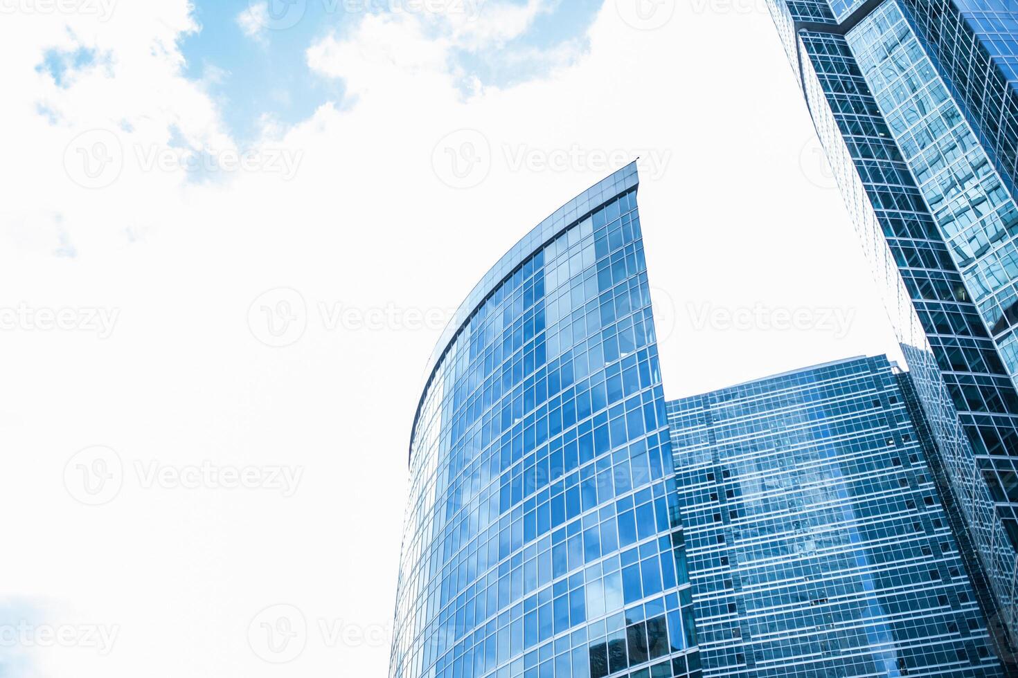 Detail blue glass building background with cloud sky photo