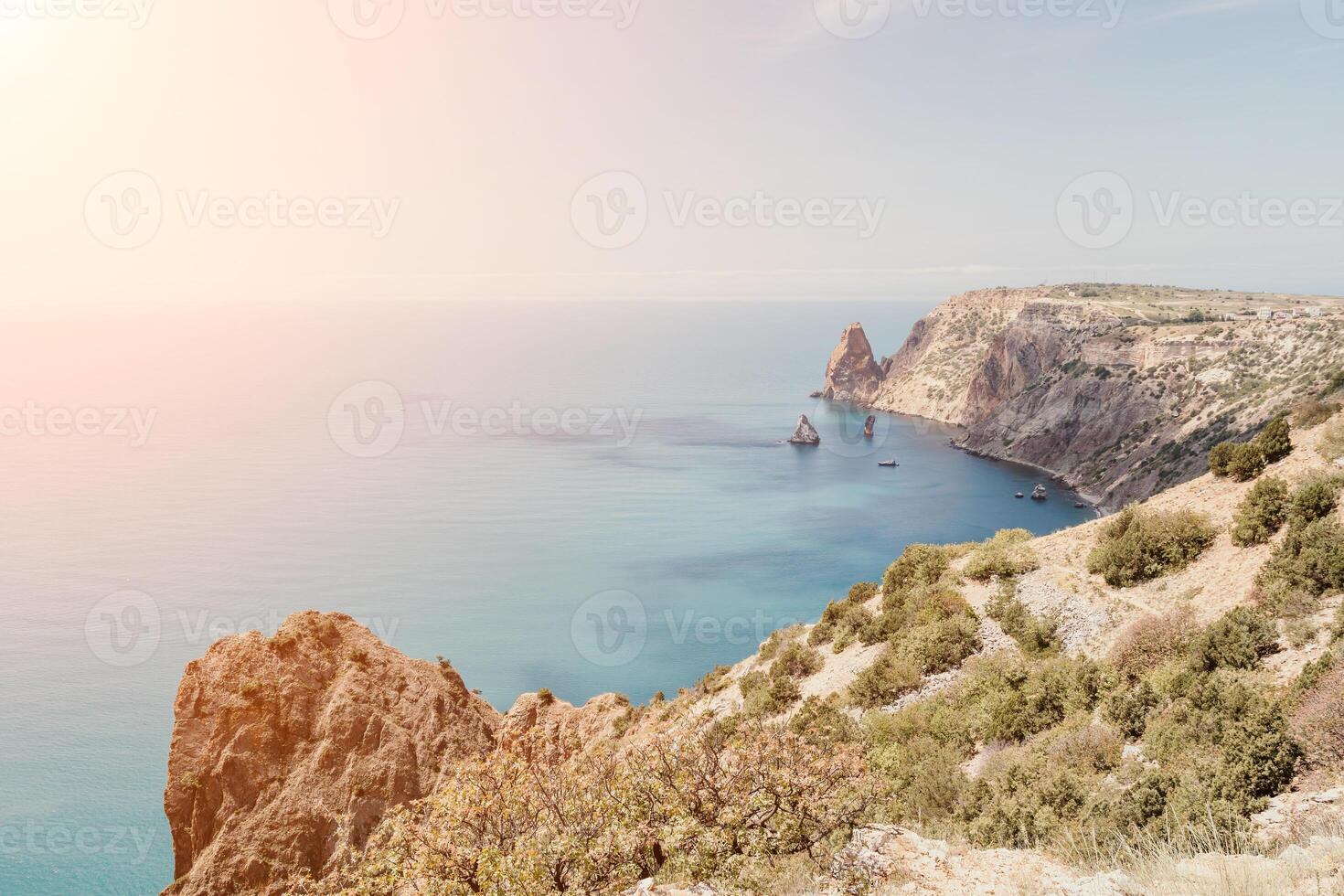 Aerial view from above on calm azure sea and volcanic rocky shores. Small waves on water surface in motion blur. Nature summer ocean sea beach background. Nobody. Holiday, vacation and travel concept photo