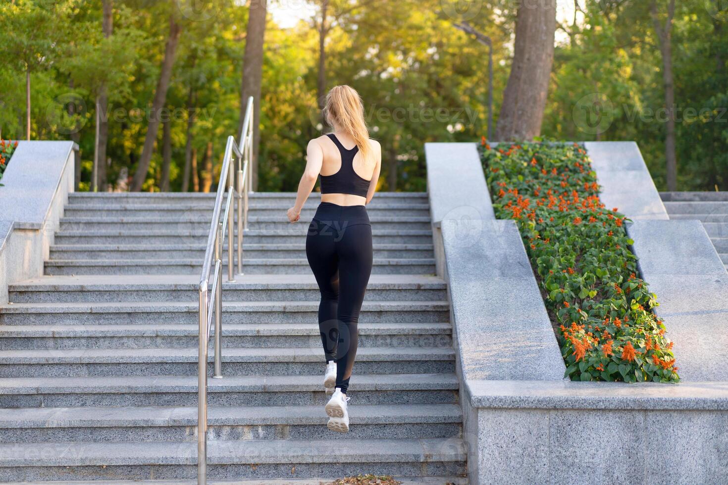 Sport and Fitness. Fit Woman Running up the steps Summer Sunny Morning Caucasian Athletic Female Jogging Outdoor Cardio Training Active Healthy Lifestyle photo