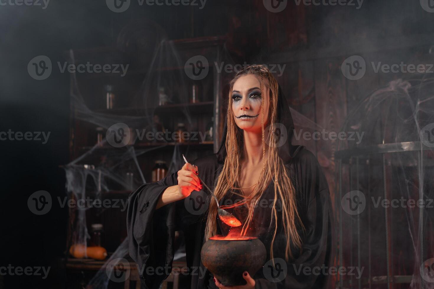 Halloween, witch use magic book and cauldron prepare poison or love potion photo