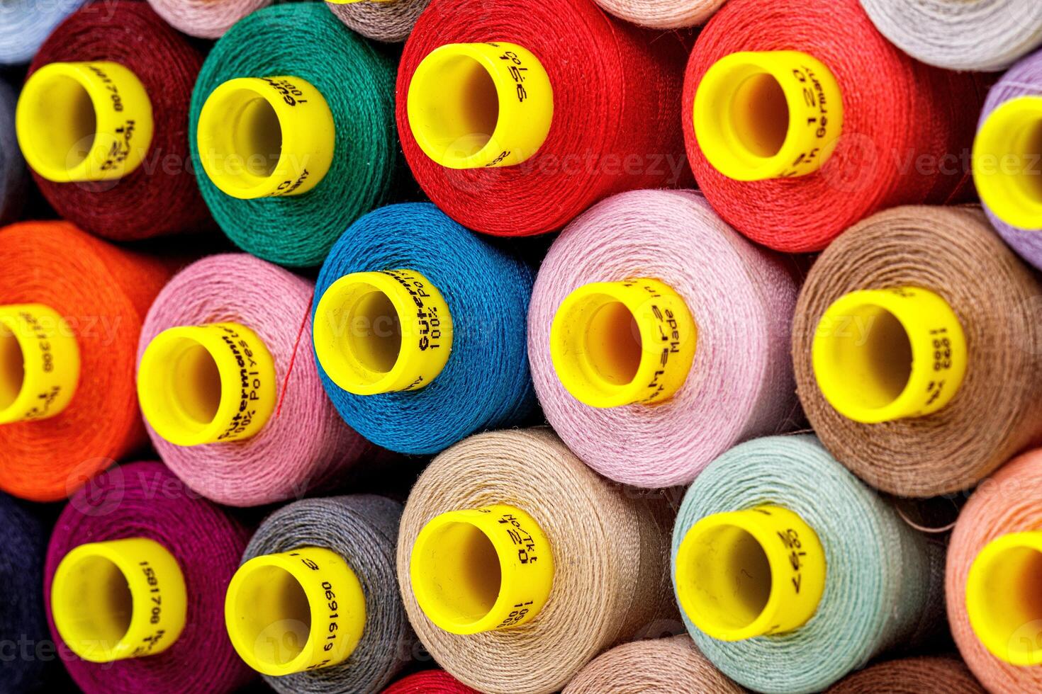 set of multi-colored spools of thread for sewing photo