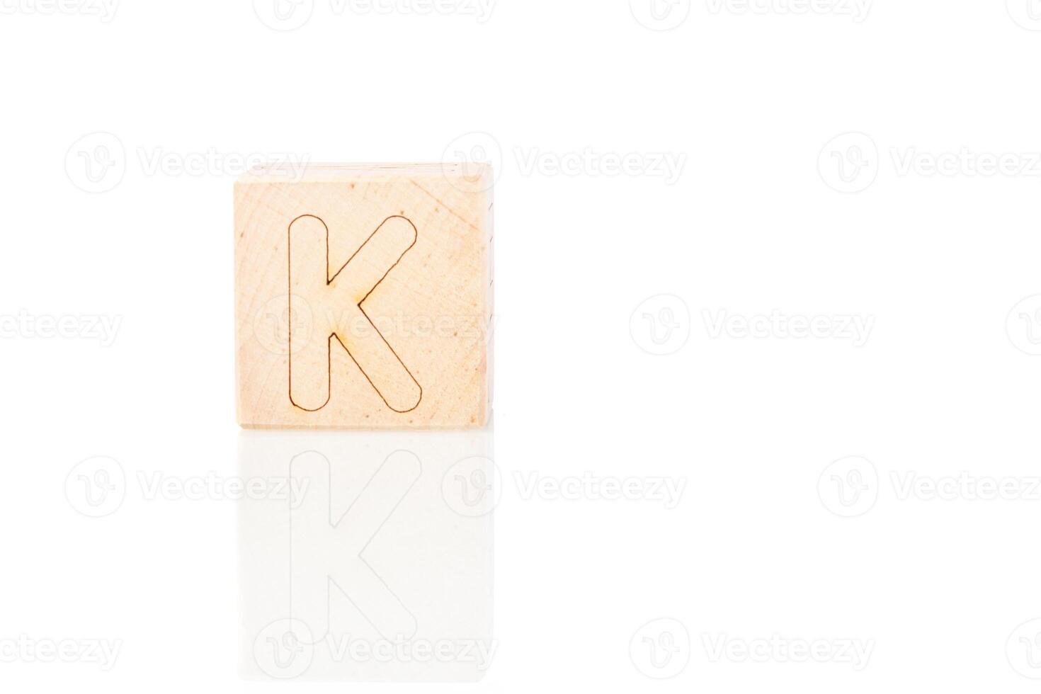 Wooden cubes with letters K on a white background photo
