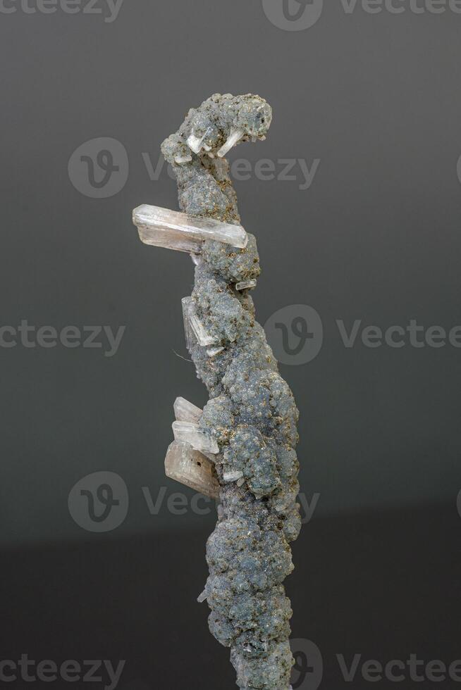 Macro mineral stone chalcedony with stelbite on a gray background photo