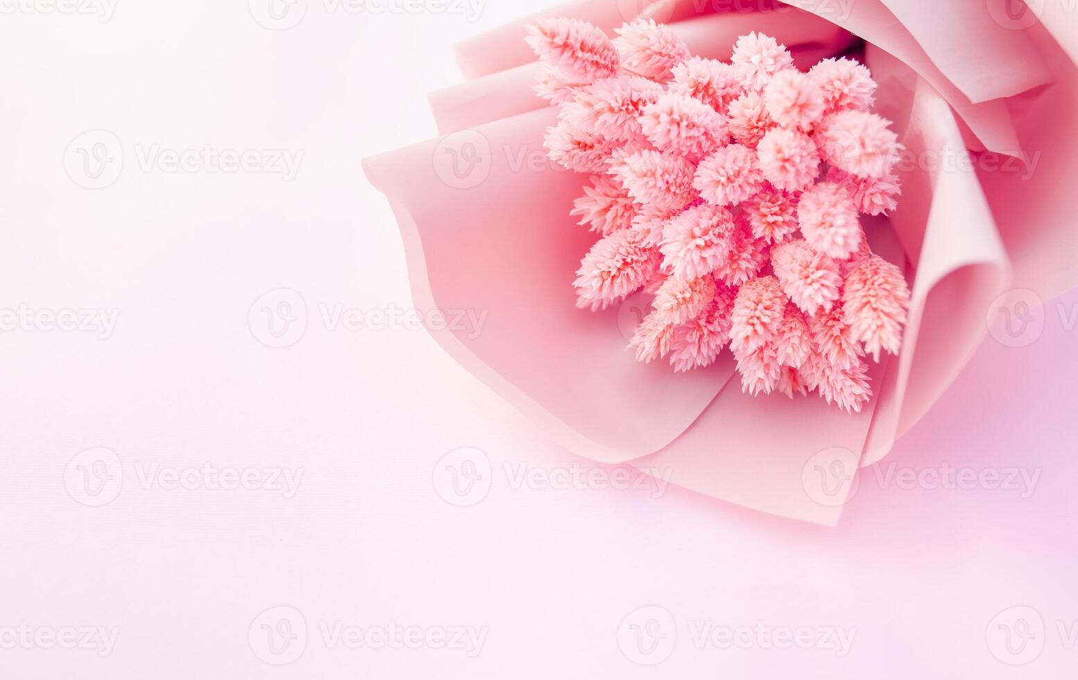 Beautiful bouquet of dry pink flowers on a wooden white background. Minimalism, space for text. Gift Card photo
