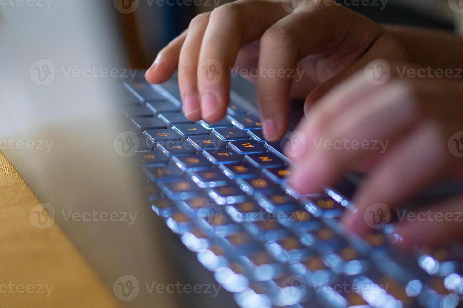 Close up image of hands typing on laptop computer keyboard and surfing the internet at home. Freelancer copywriter working project, typing text, edit something. Remote job concept photo