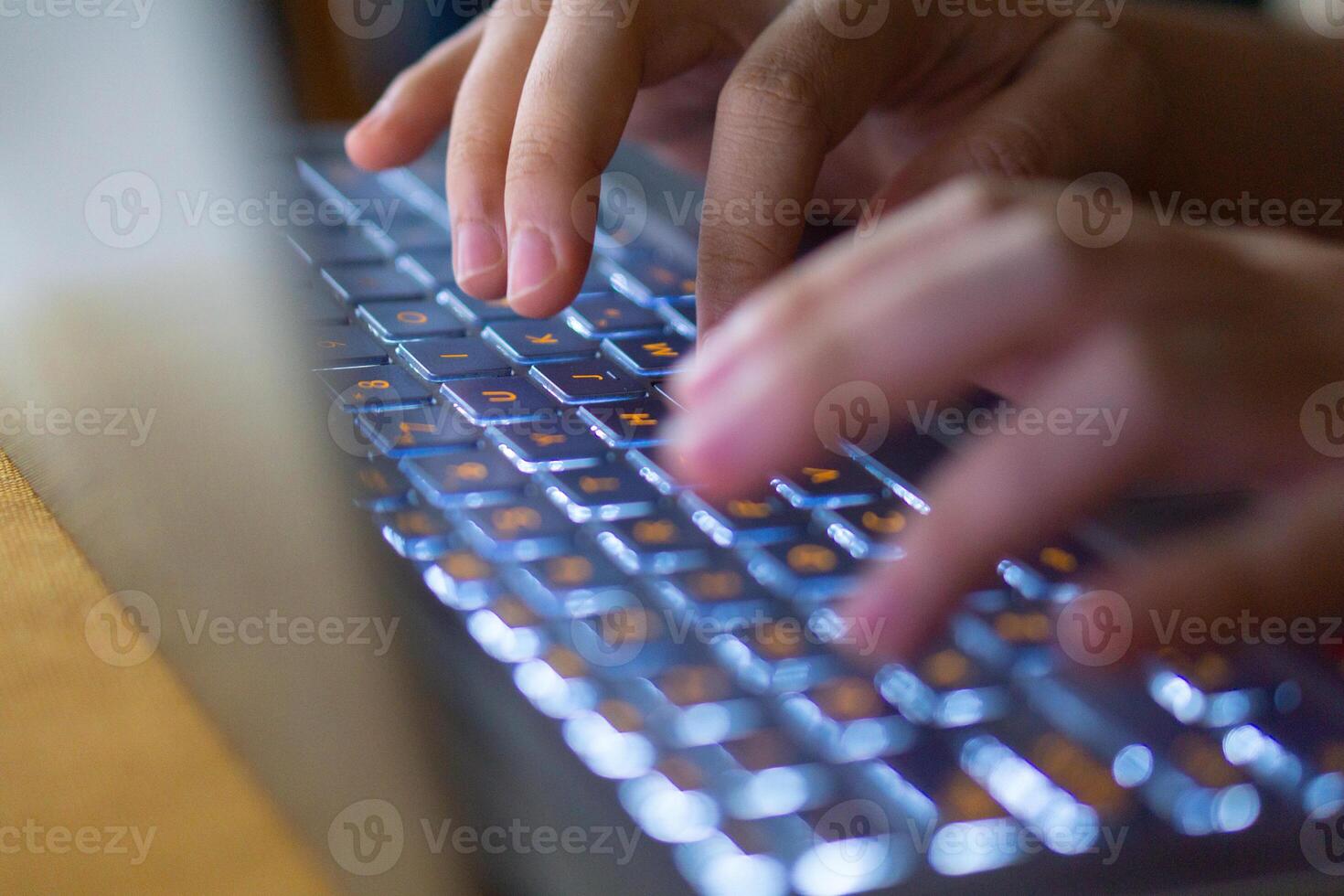 Close up image of hands typing on laptop computer keyboard and surfing the internet at home. Freelancer copywriter working project, typing text, edit something. Remote job concept photo