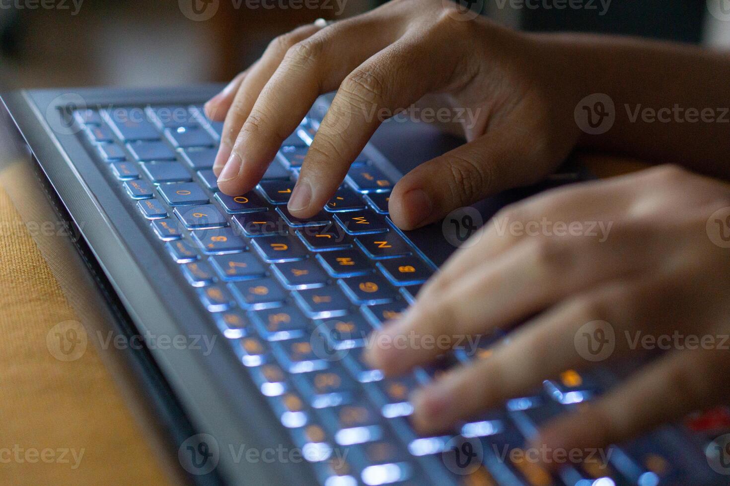 Close up image of hands typing on laptop computer keyboard and surfing the internet at home. Freelancer copywriter working project, typing text, edit something. Remote job concept photo