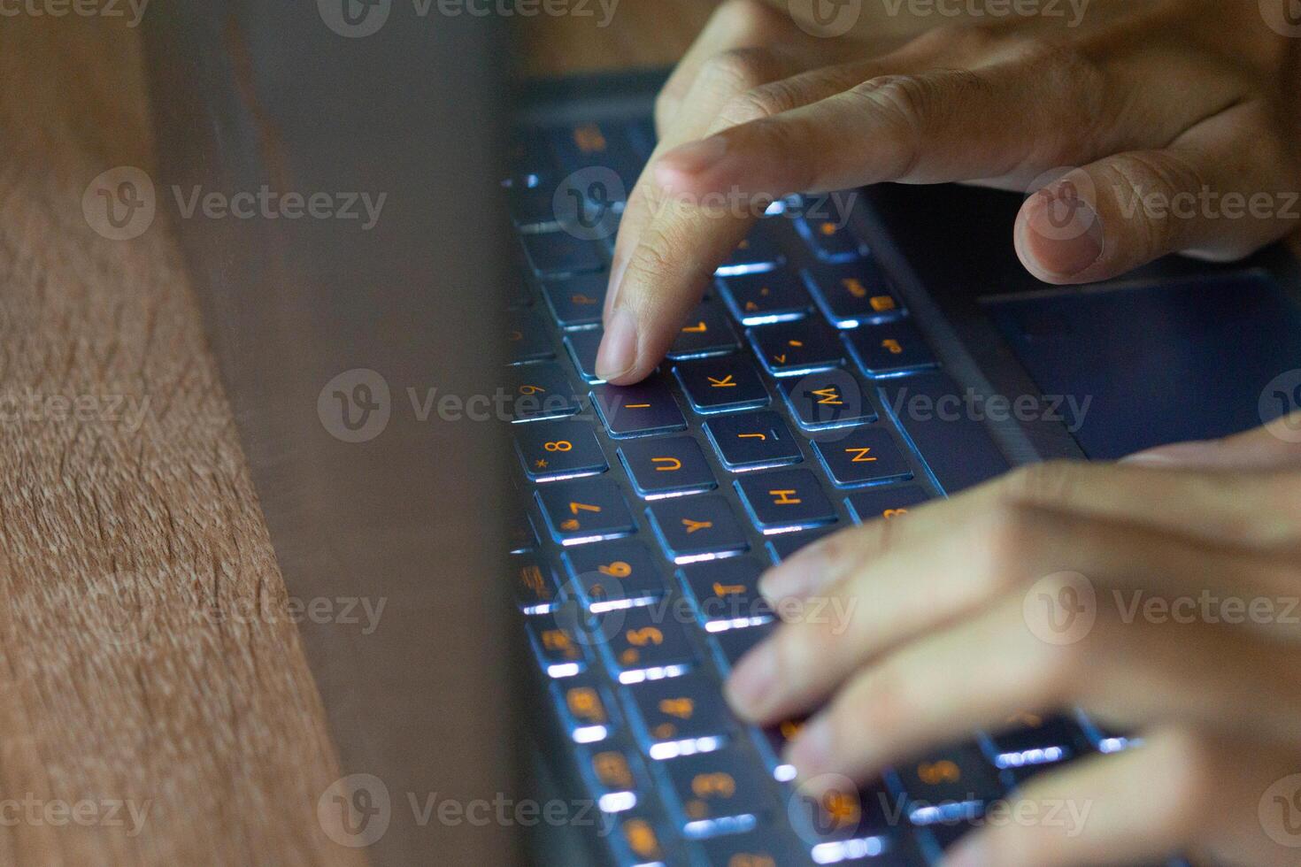 Close up image of hands typing on laptop computer keyboard and surfing the internet at home. Freelancer copywriter working project, typing text, edit something. Remote job concept photo