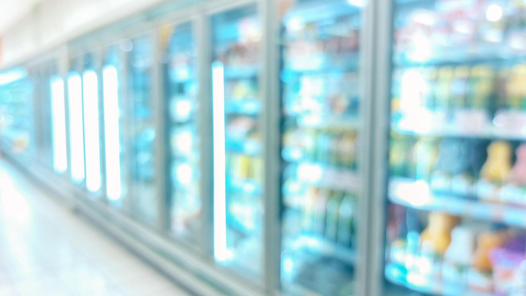 supermarket aisle and shelves blurred background. grocery store retail business concept photo