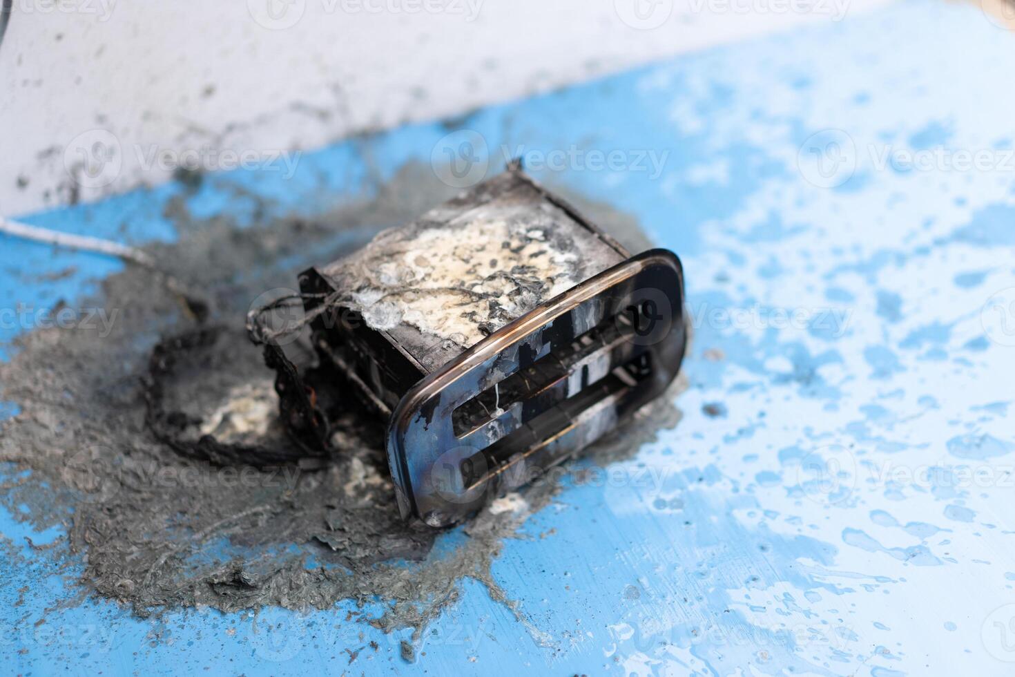 Toaster after fire. Household electrical appliance fire hazard photo