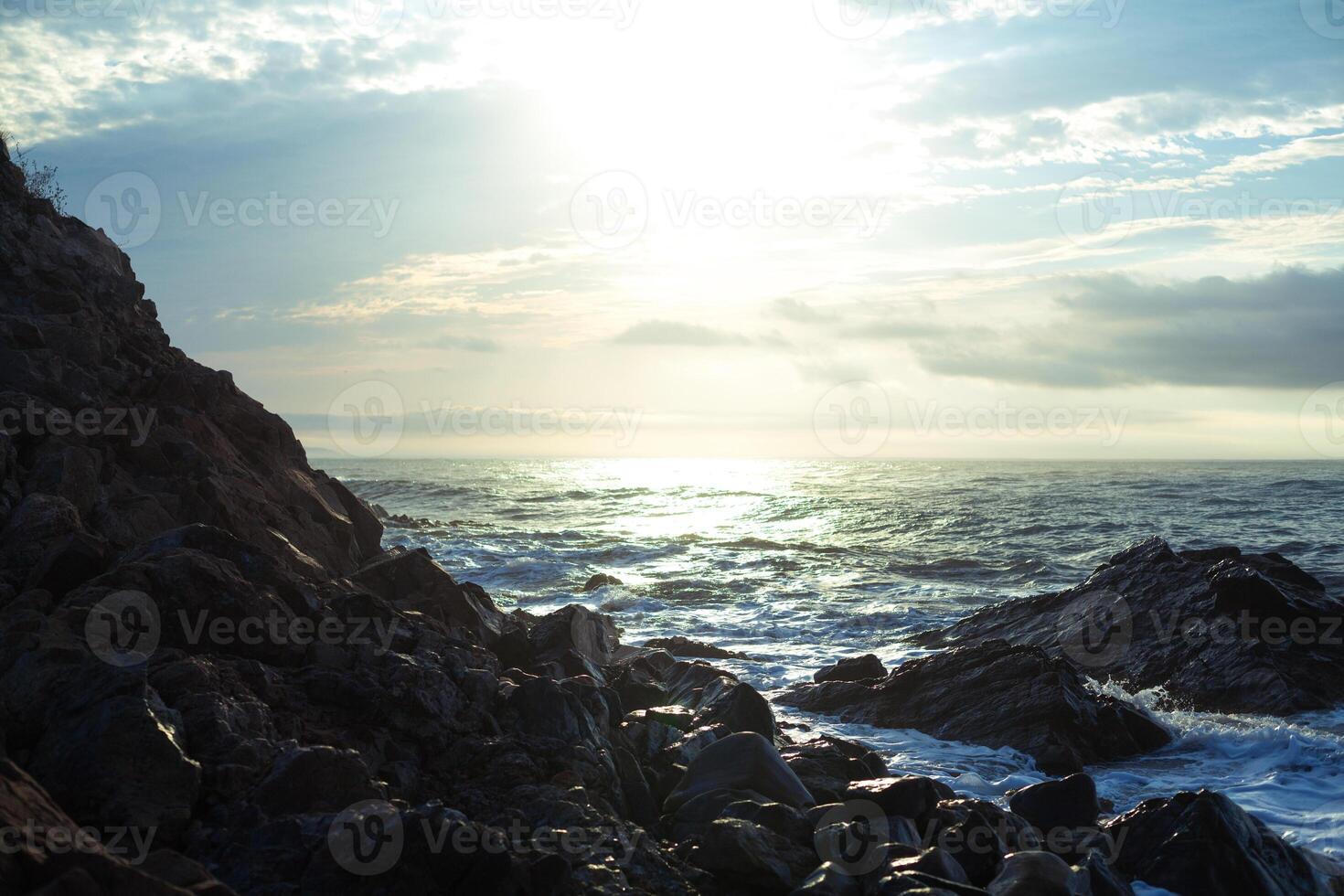 sharped rock in the sea or ocean wave photo