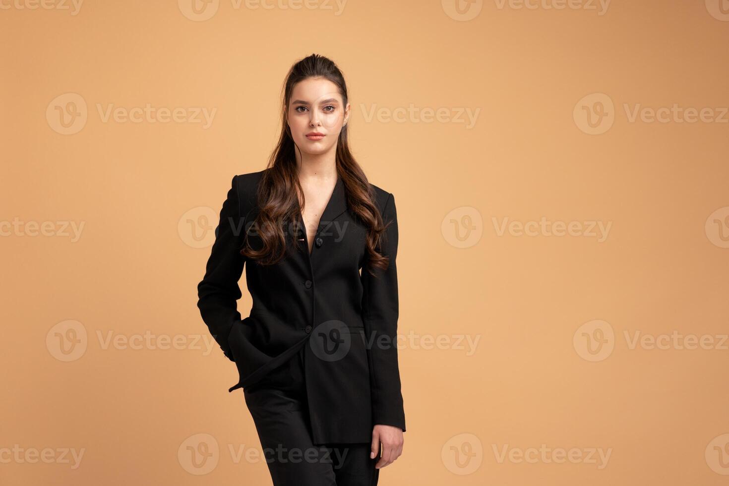 Young business woman one hand in pocket dressed black jacket standing studio isolated on color background. photo