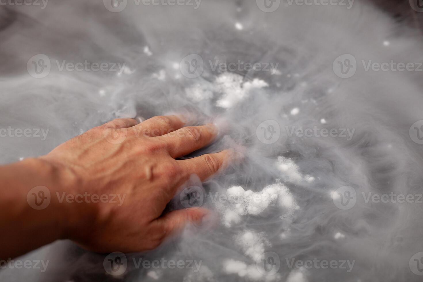 Thick white smoke on a background of black ceramic tiles. photo