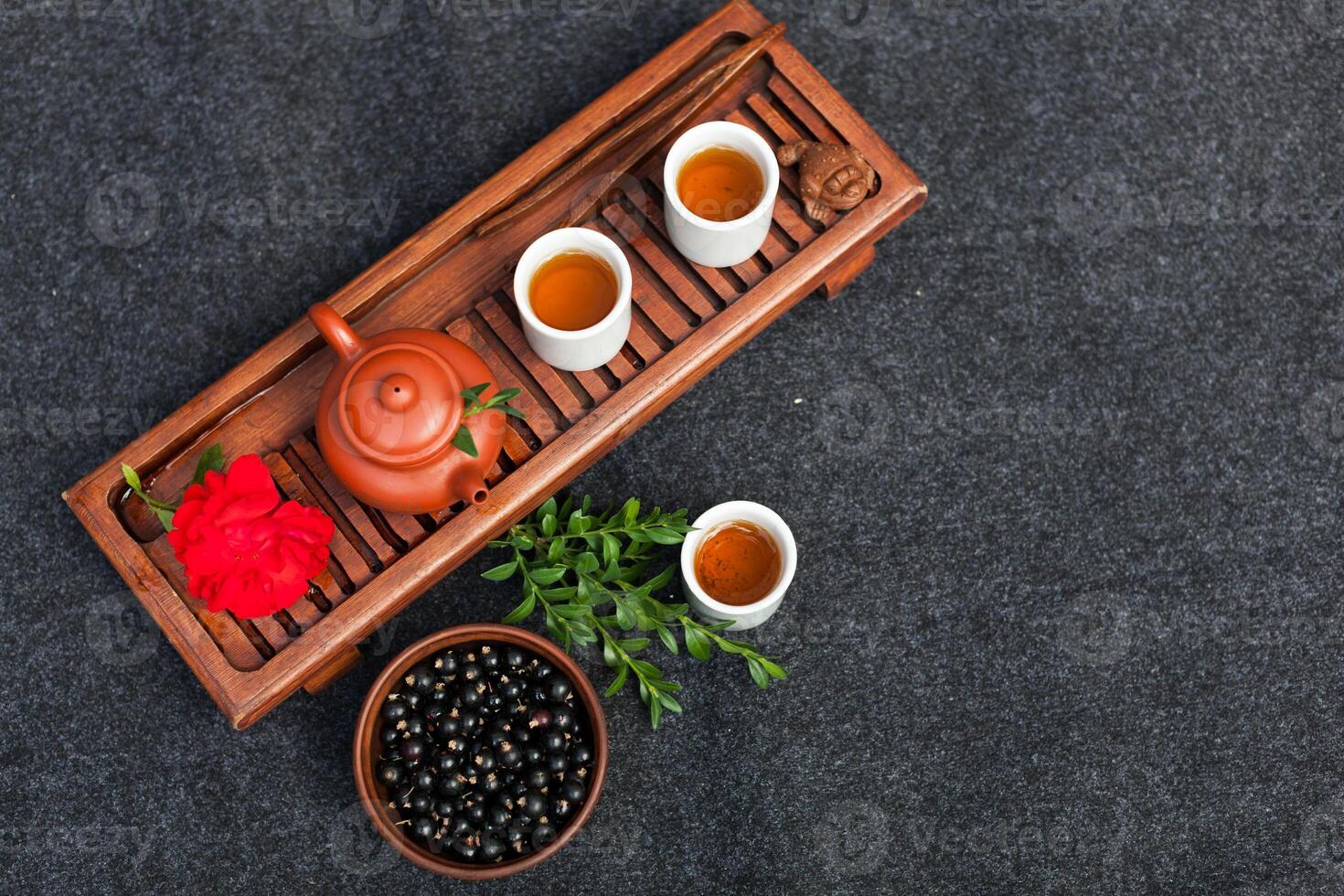 Traditional Chinese tea ceremony with black currant, fruit tea and healthy food. Photo without people. Summer natural vitamins and berries