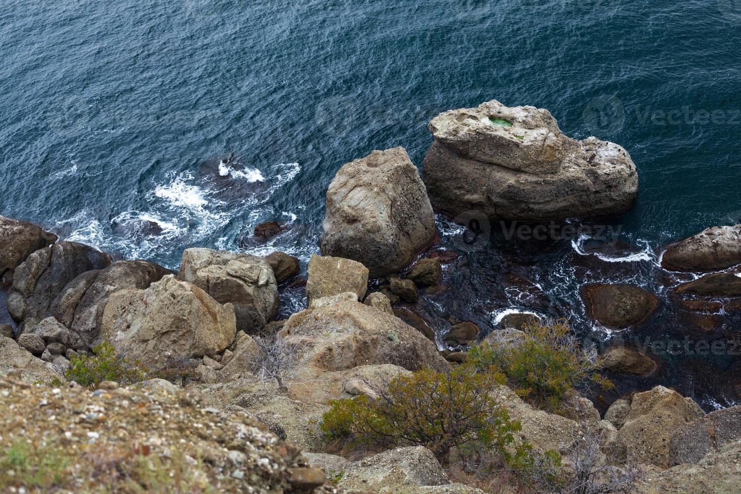 big stone rock over the sea water photo