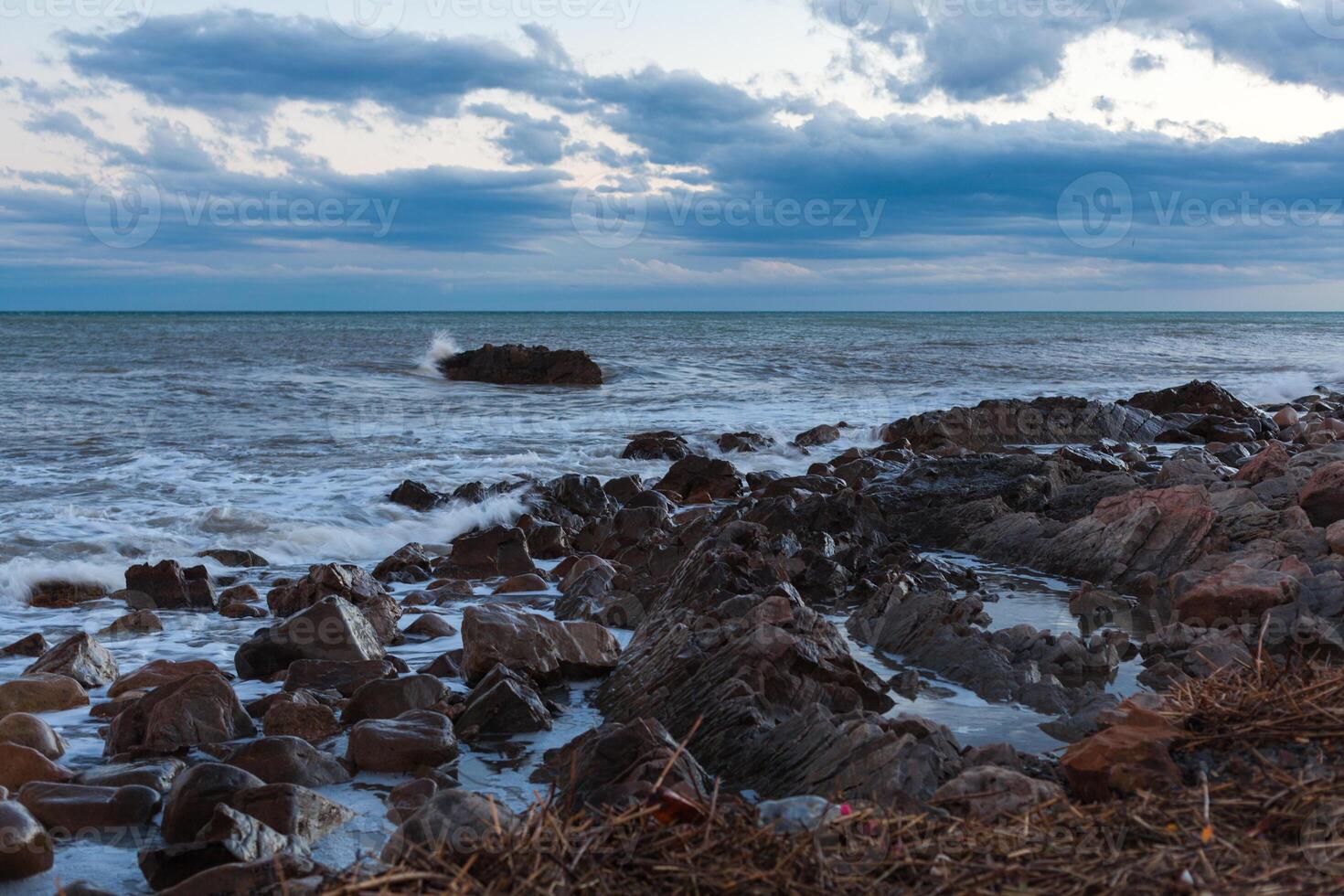 sharped stone in the sea or ocean foam wave photo