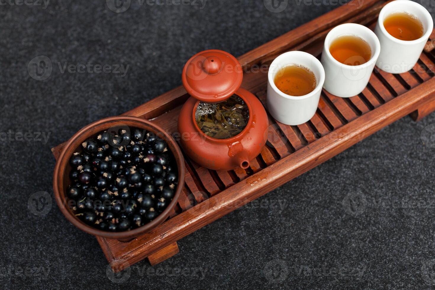 Traditional Chinese tea ceremony with black currant, fruit tea and healthy food. Photo without people. Summer natural vitamins and berries