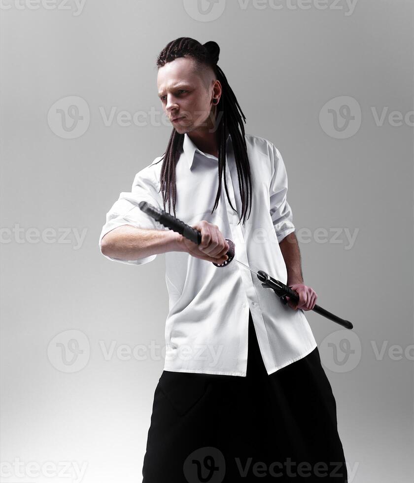 Young man holding a samurai sword. Glamour photo. photo