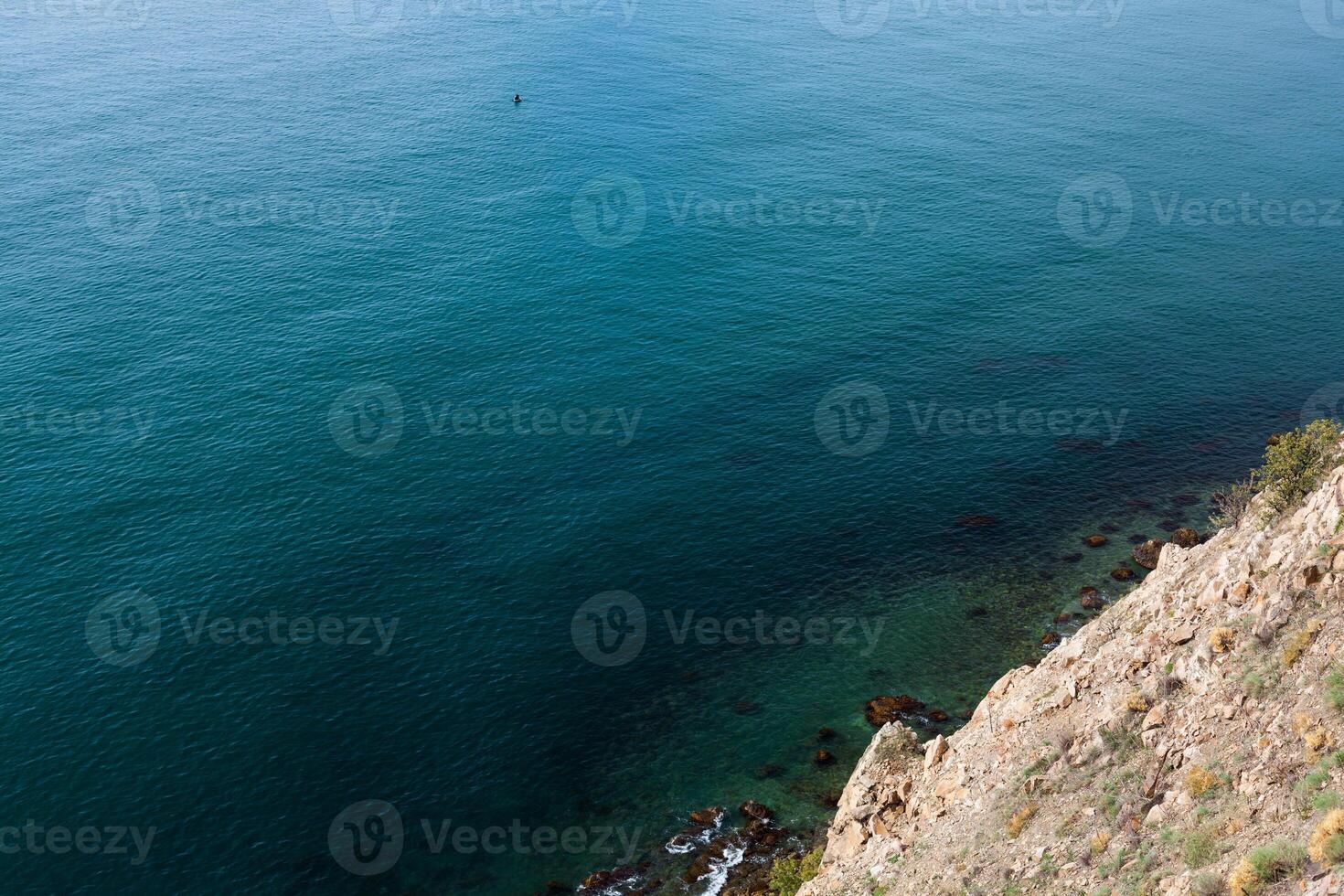 sea wave washes yellow beach of pebbles photo